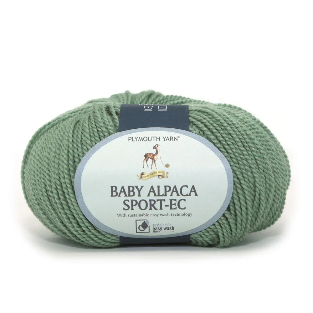 Baby alpaca sport-weight yarn skein in green with product label