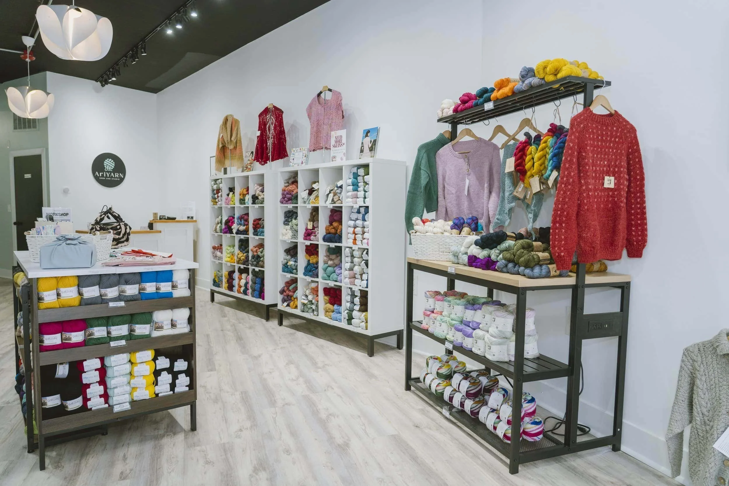 Interior of AriYARN Shop & Studio with yarn display wall and cozy seating in Park Ridge, Illinois.