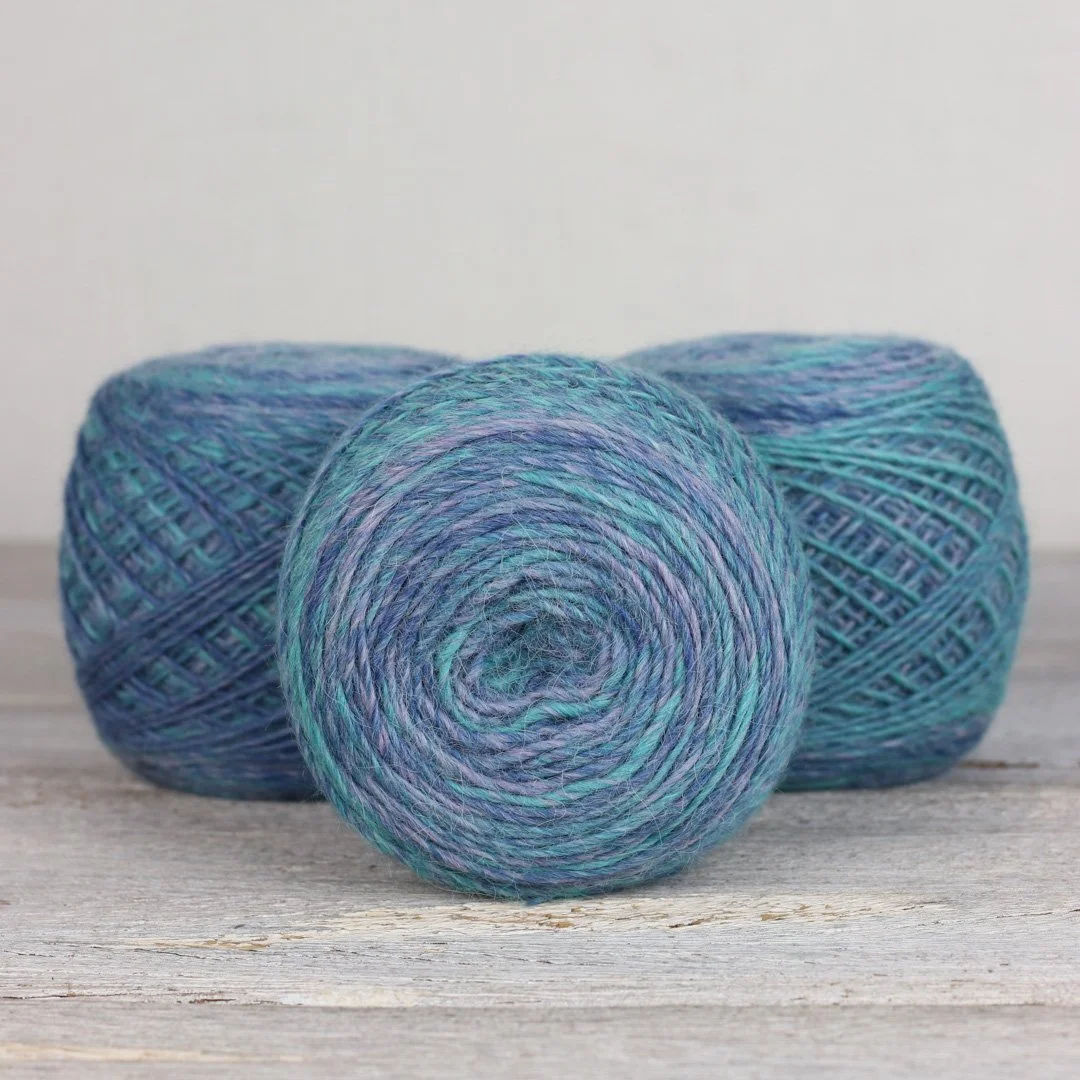 The Fibre Co. Transitions yarn in blue and green shades, three yarn balls at AriYARN