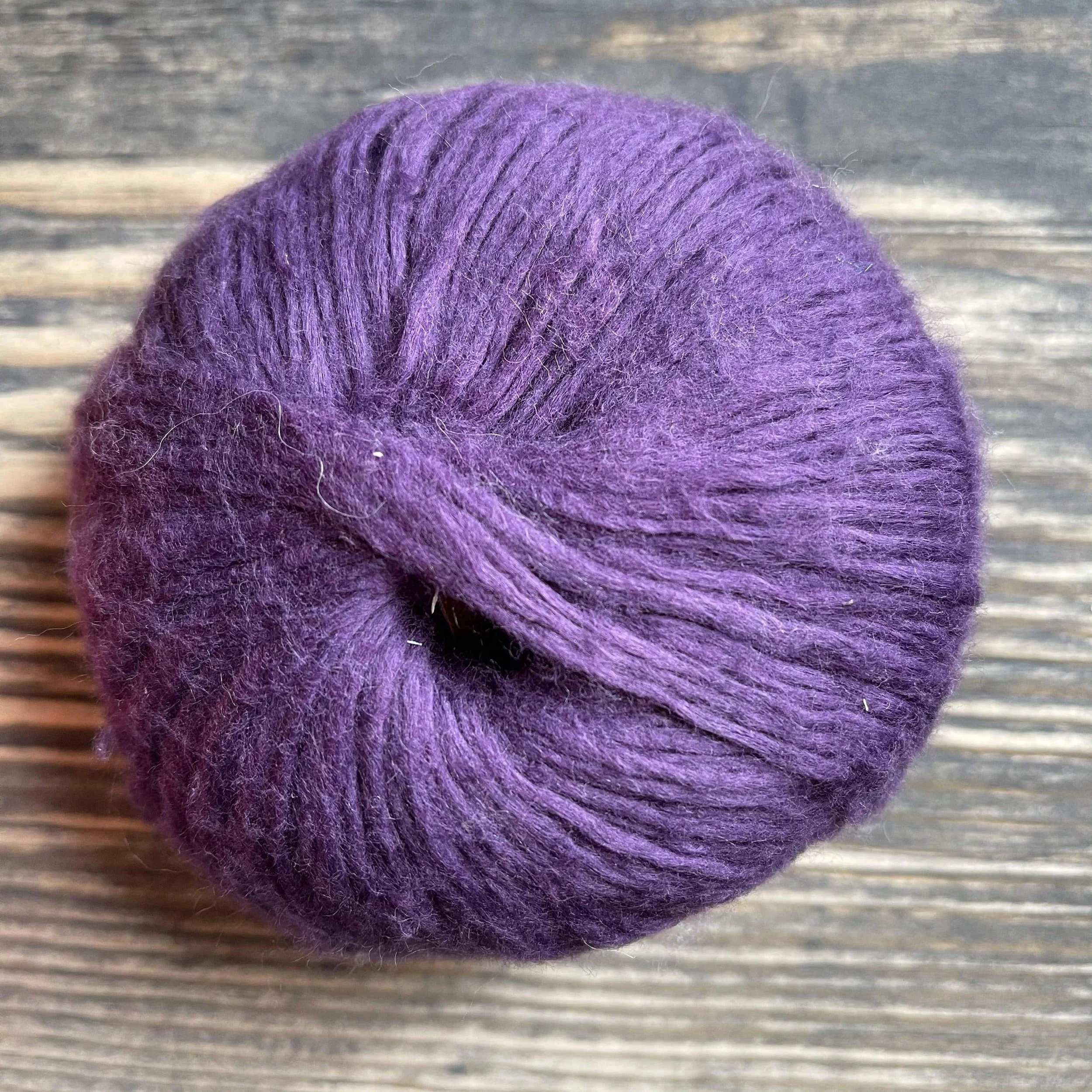 Pascuali Suave yarn in deep blackberry purple, soft ball