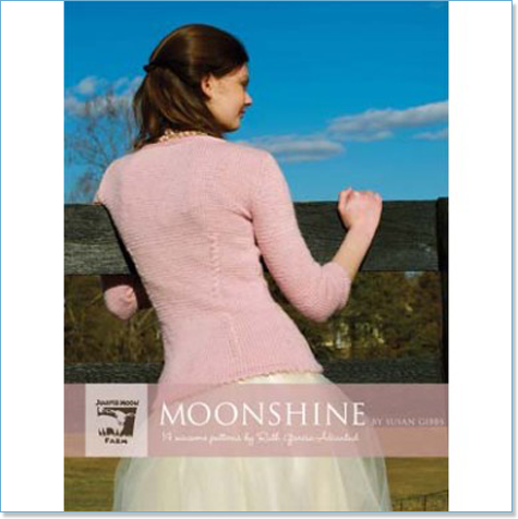 Juniper Moon Farm Moonshine pattern book cover with a pink handknit sweater shown from behind outdoors
