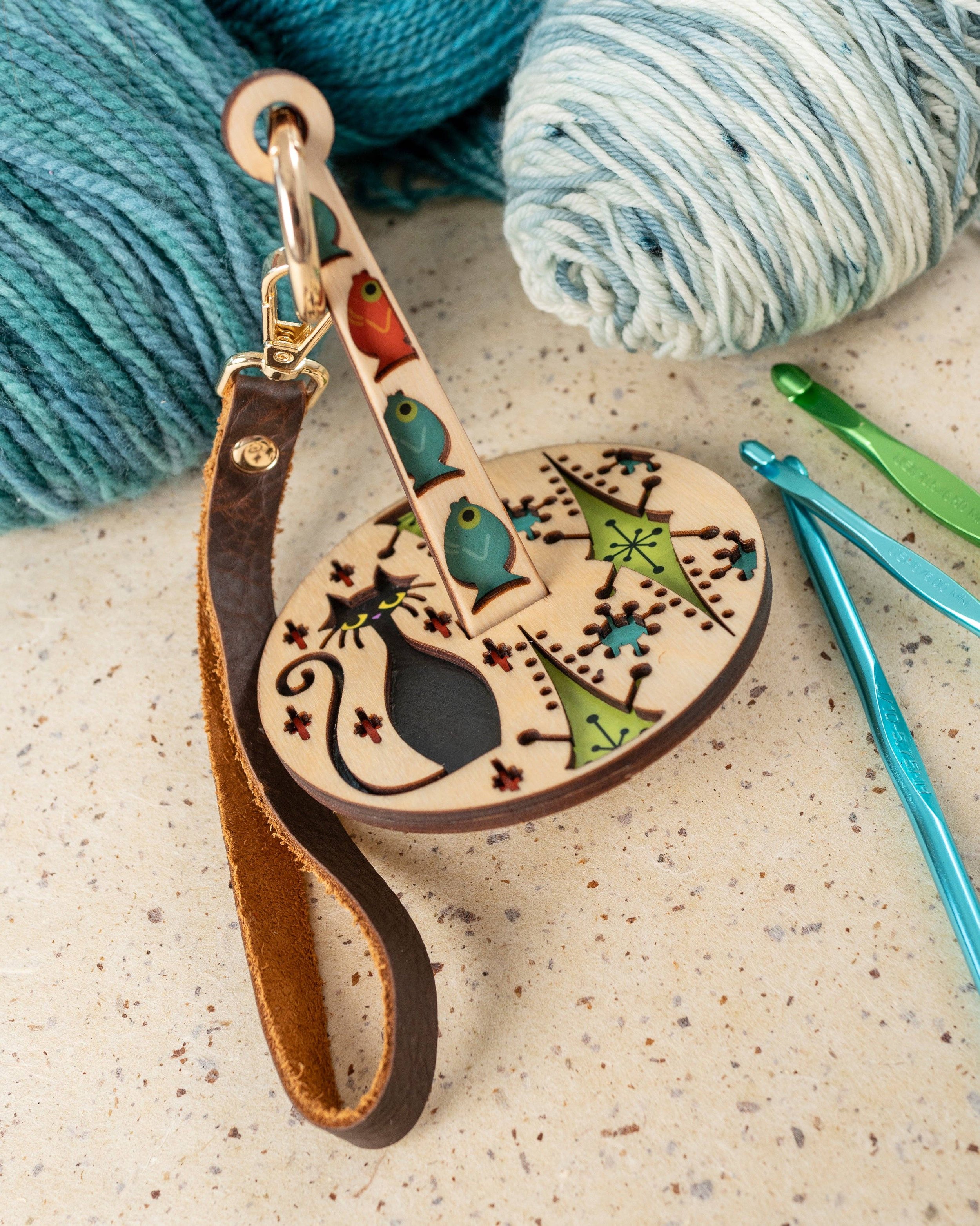 Round cat pendant yarn accessory with leather wrist strap, Lemonwood-style laser-cut wood
