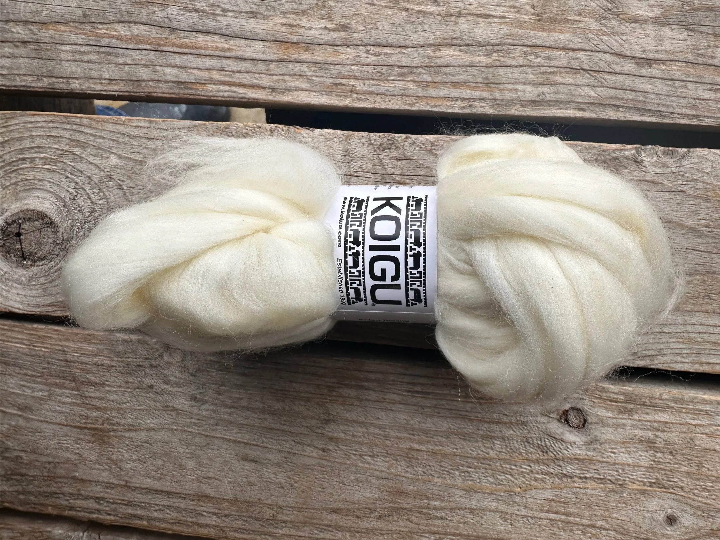 Koigu felting fiber bundle in white on wood background