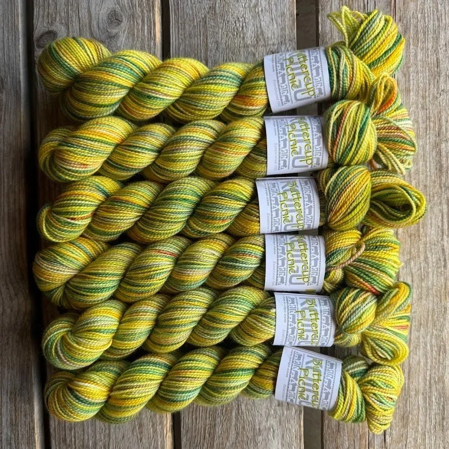 Koigu KPPPM handpainted merino yarn skeins in buttercup yellow tones