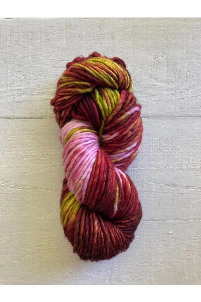 Hand-dyed yarn skein with red yellow and pink gradient from Manos del Uruguay