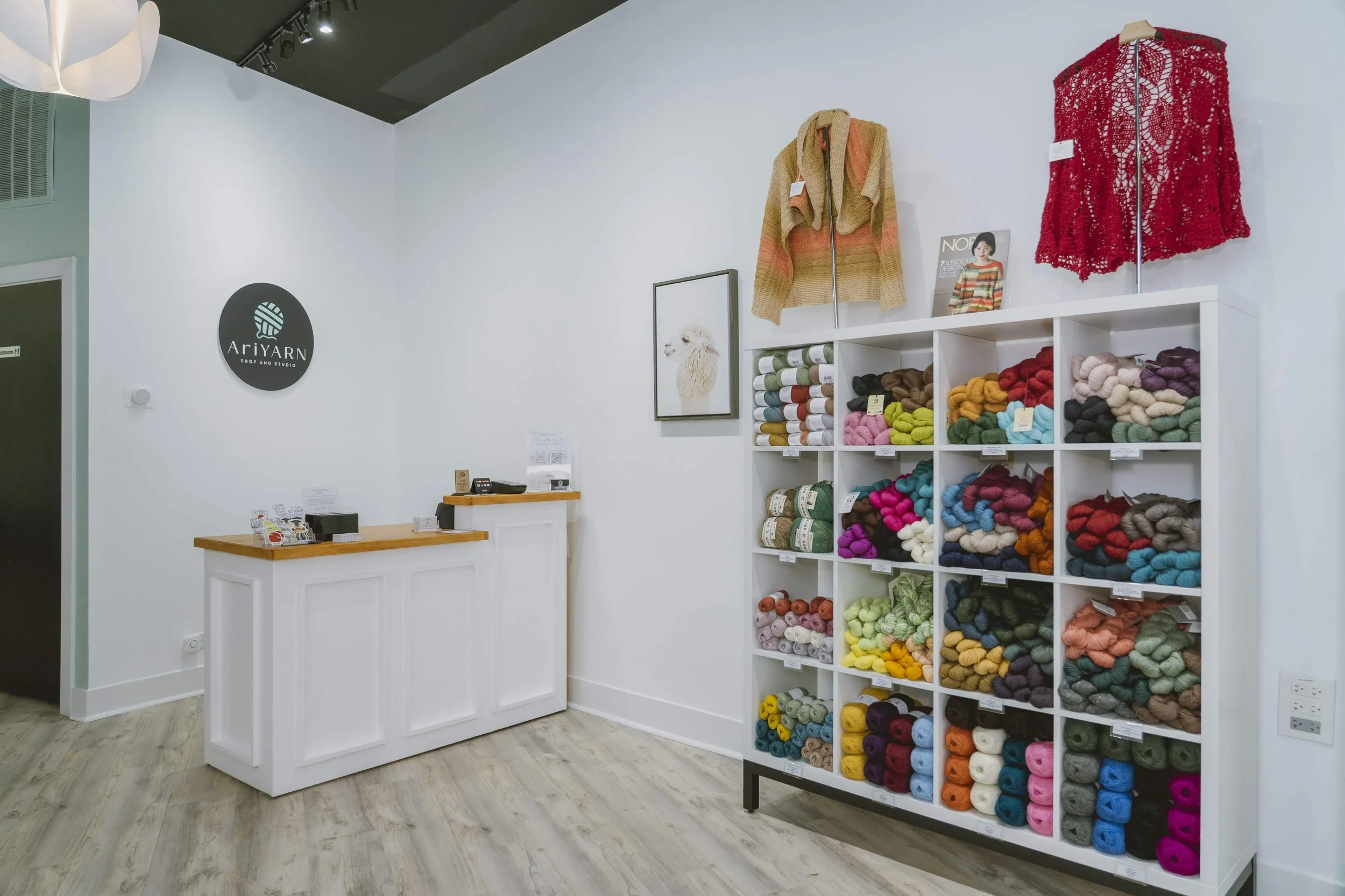 AriYARN checkout counter and yarn wall with finished samples in Park Ridge
