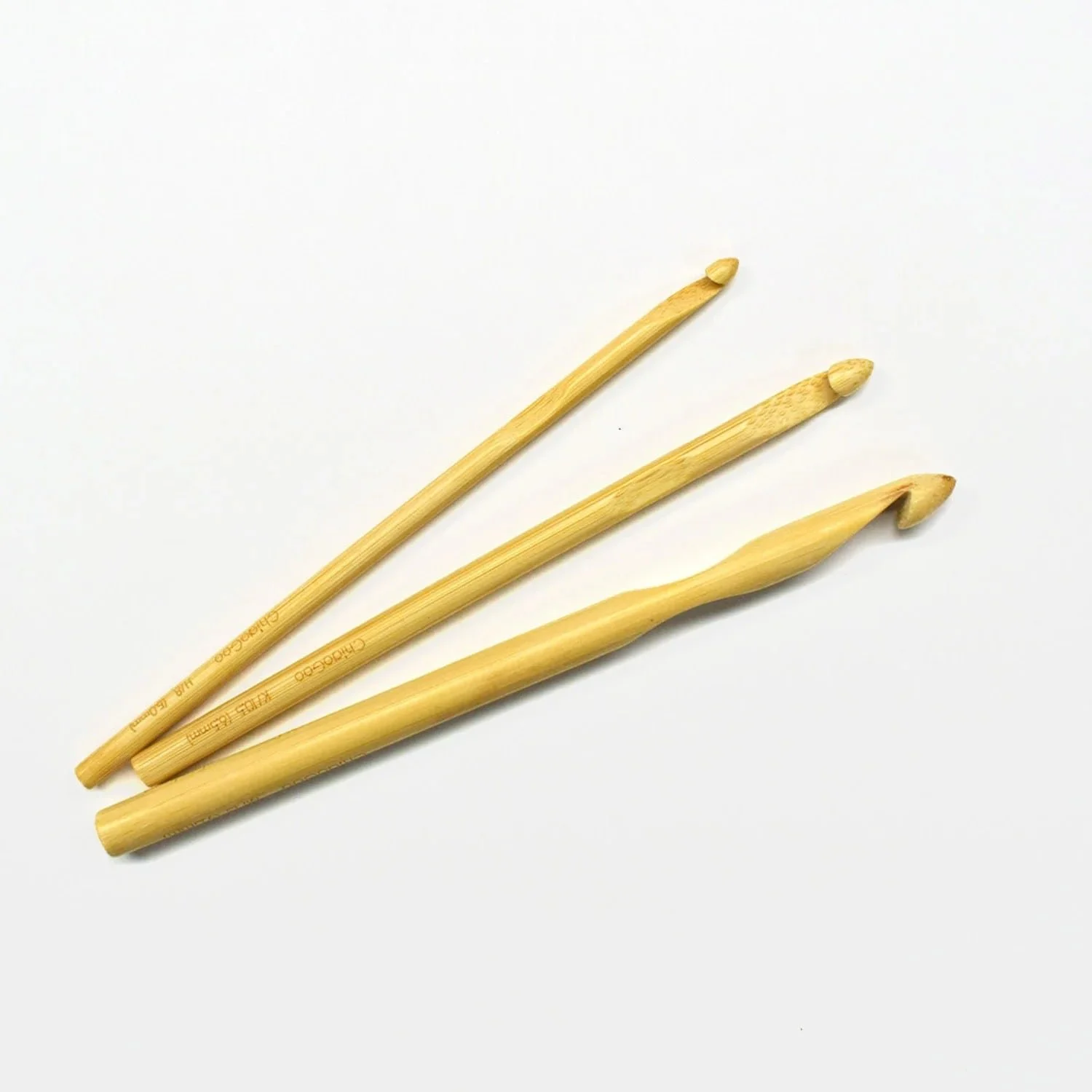 Ergonomic crochet hooks arranged over a pattern page.