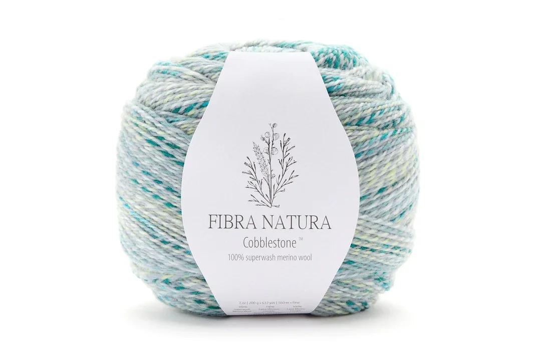Fibra Natura Cobblestone superwash merino wool yarn in speckled colorway perfect for sweater knitting and crochet garments
