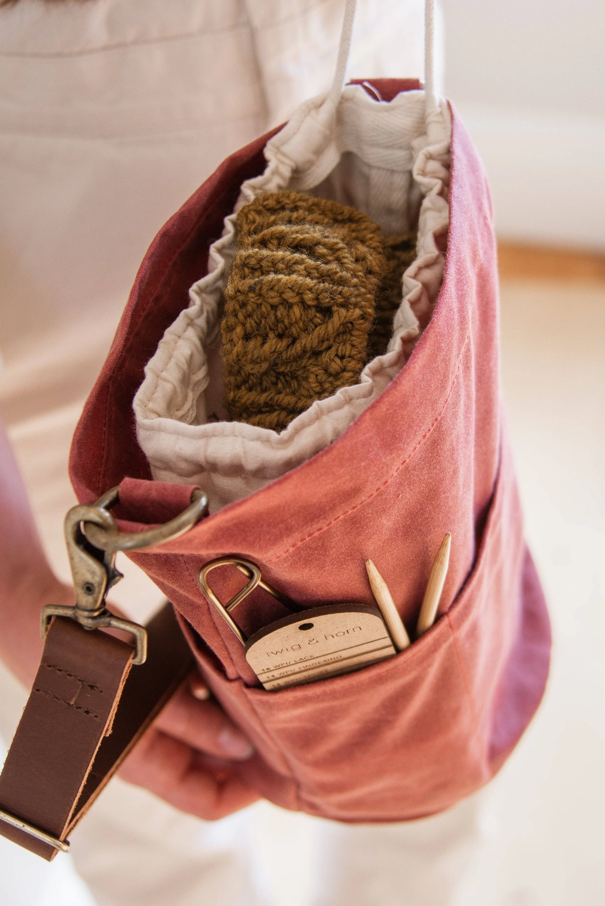 Close-up of waxed canvas bucket bag showing stitching, texture, and durable construction.