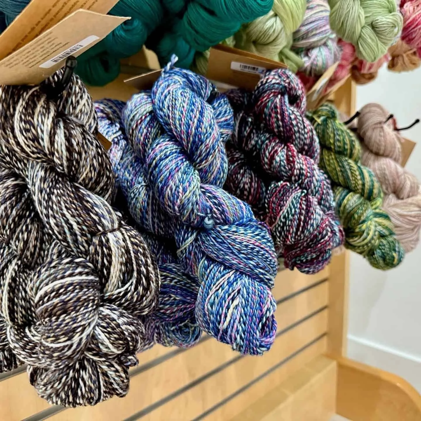 Close-up of colorful hand-dyed yarn skeins on display at AriYARN Shop and Studio in Park Ridge, near Chicago