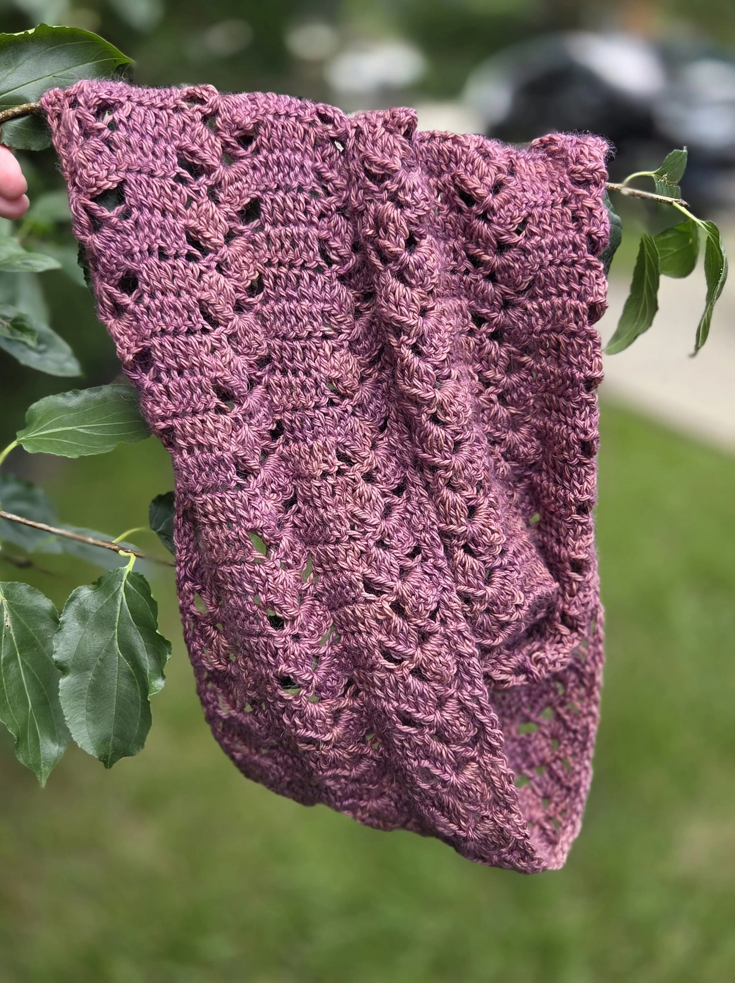 Dusty-rose crocheted lace infinity scarf draped to show openwork.