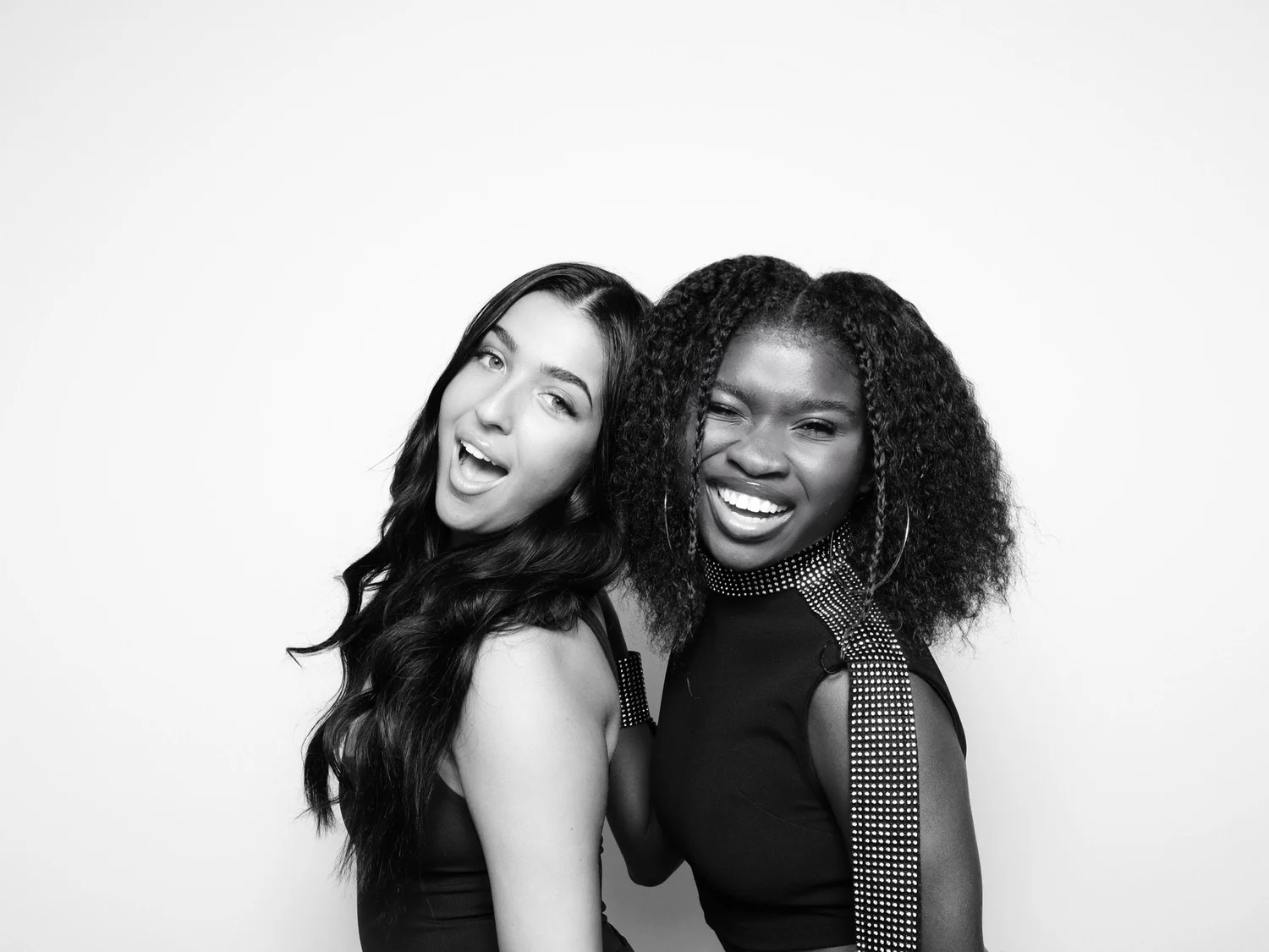 Black and white glam booth portrait of two friends