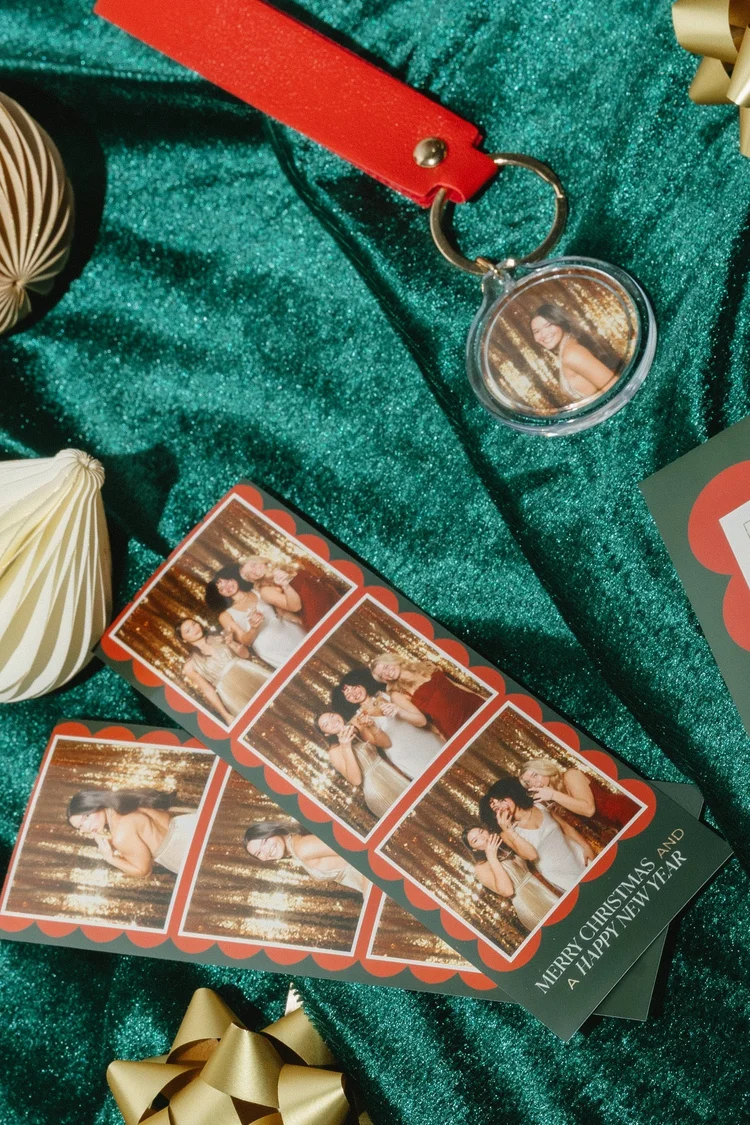 Photo booth strips and ornaments on green velvet