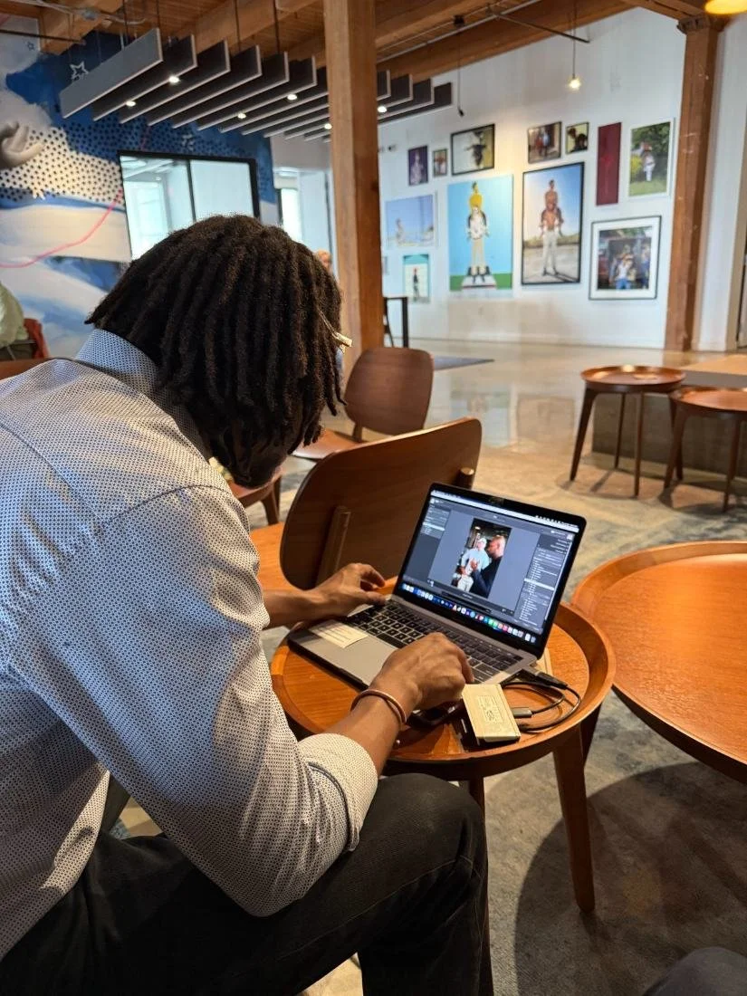 Long-table work sessions, laptops open, one deadline.