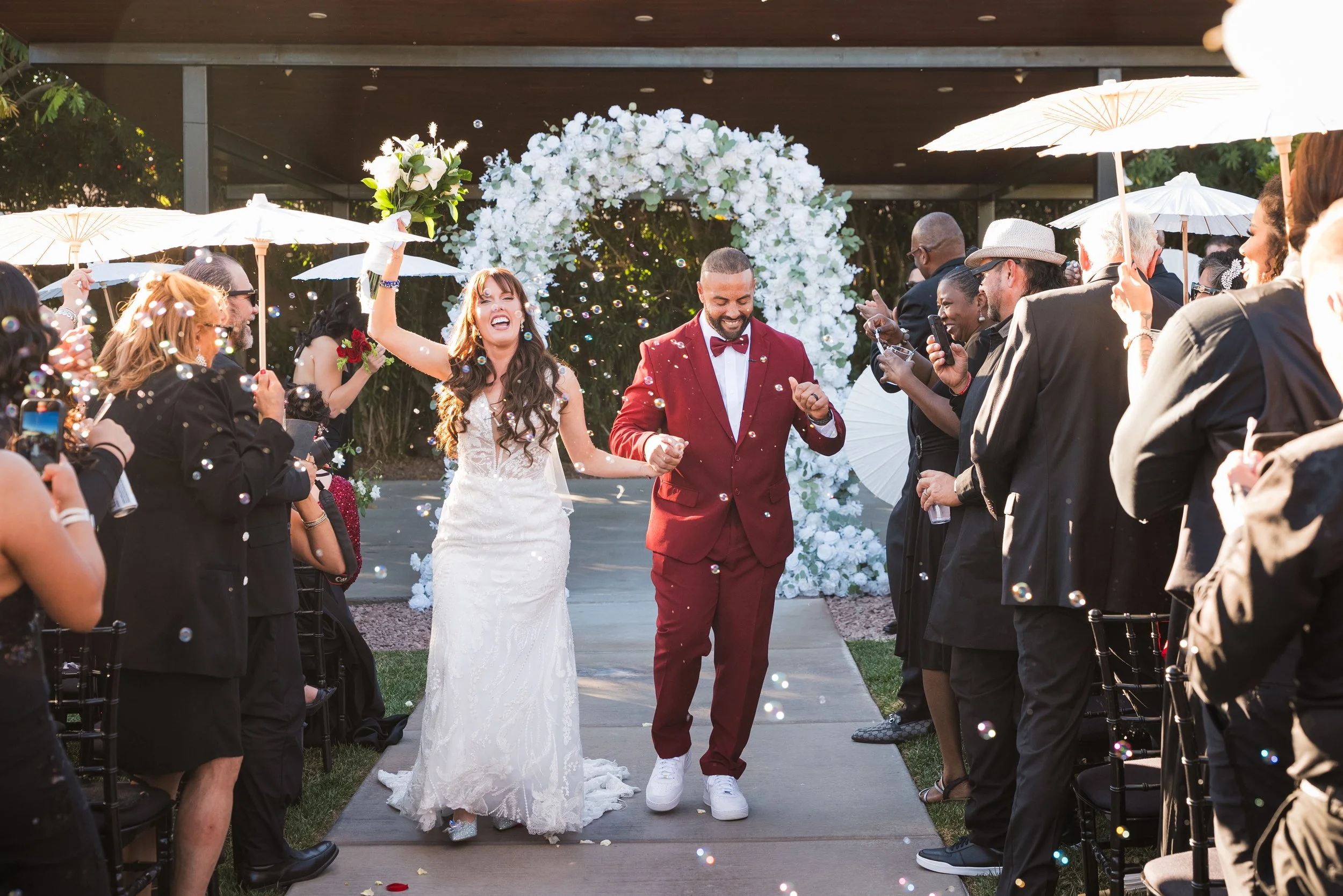 Bride and Groom celebrating walking down aisle together