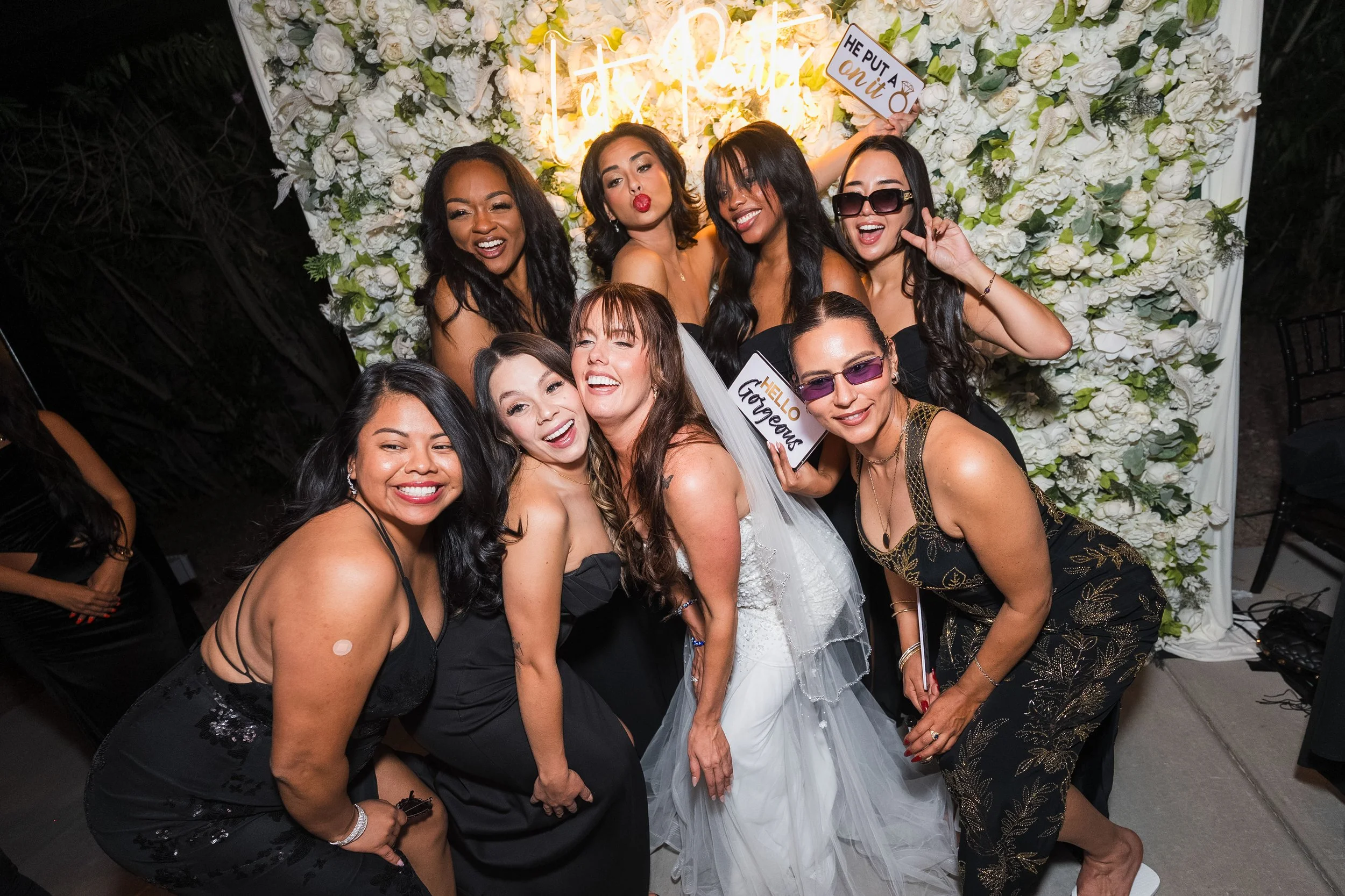 Bride laughing with her bridesmaids and friends during reception