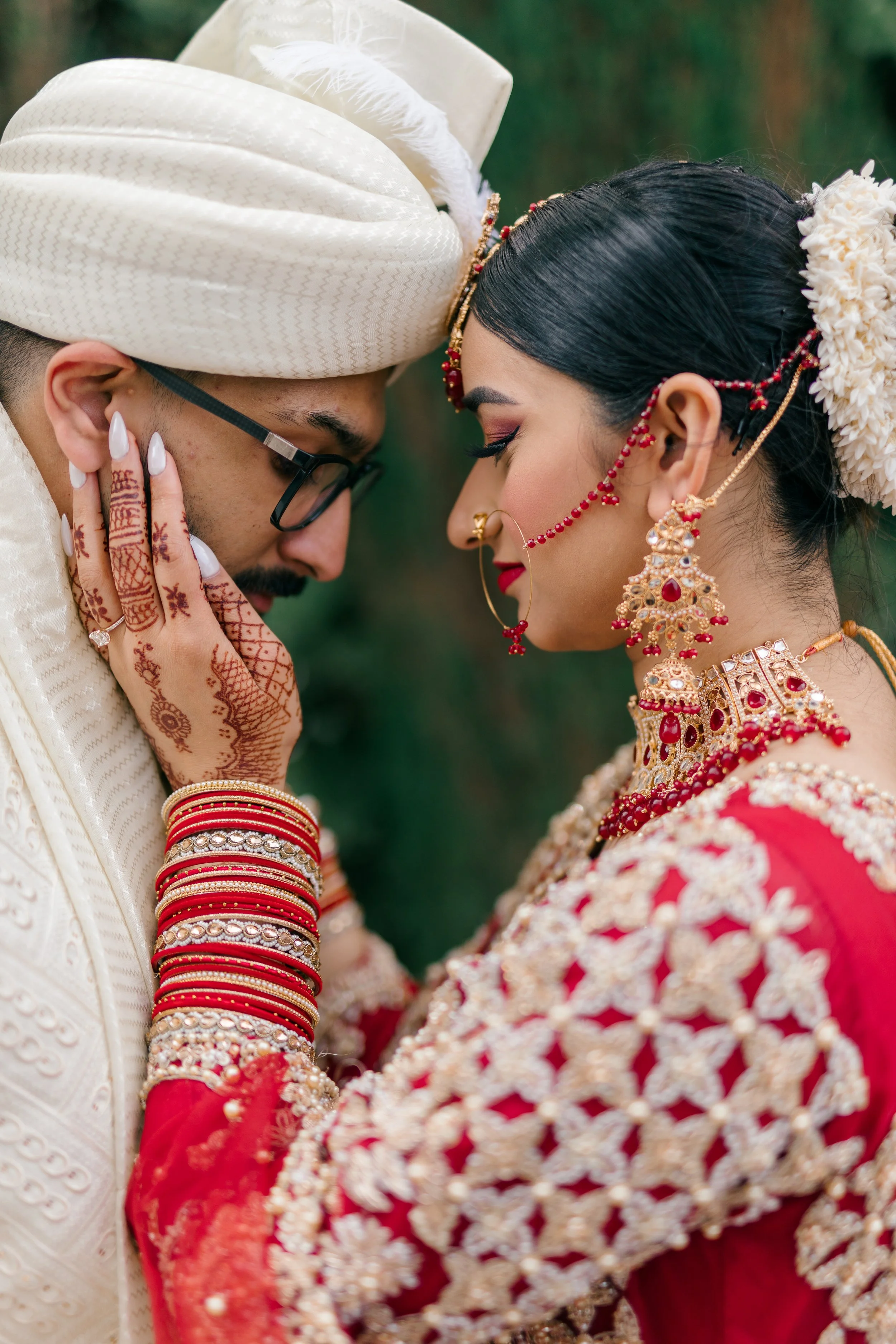 Close, intimate portrait of a bride and groom in traditional wedding attire