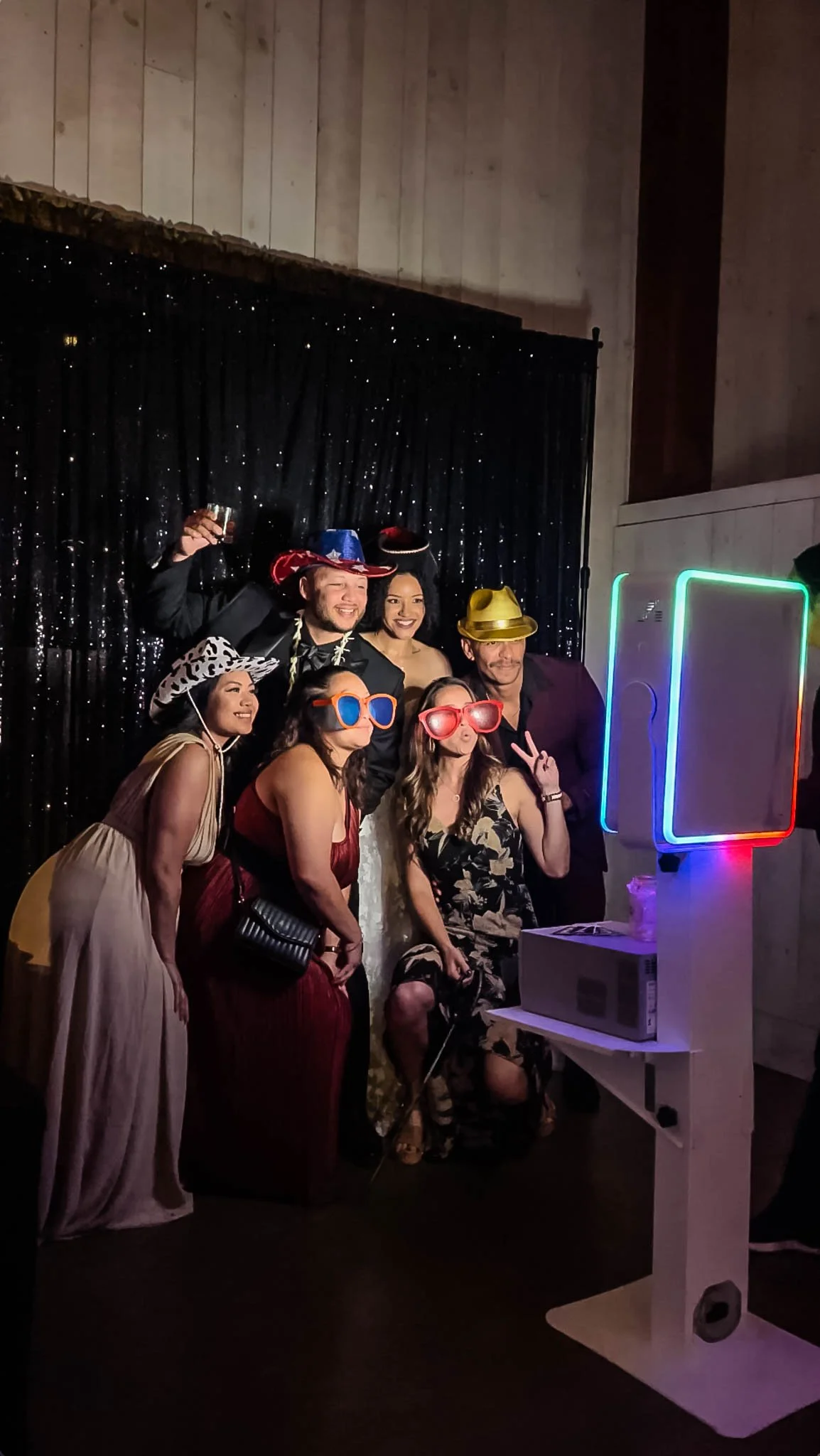 Wedding guests enjoying a joyful photo booth experience at a reception