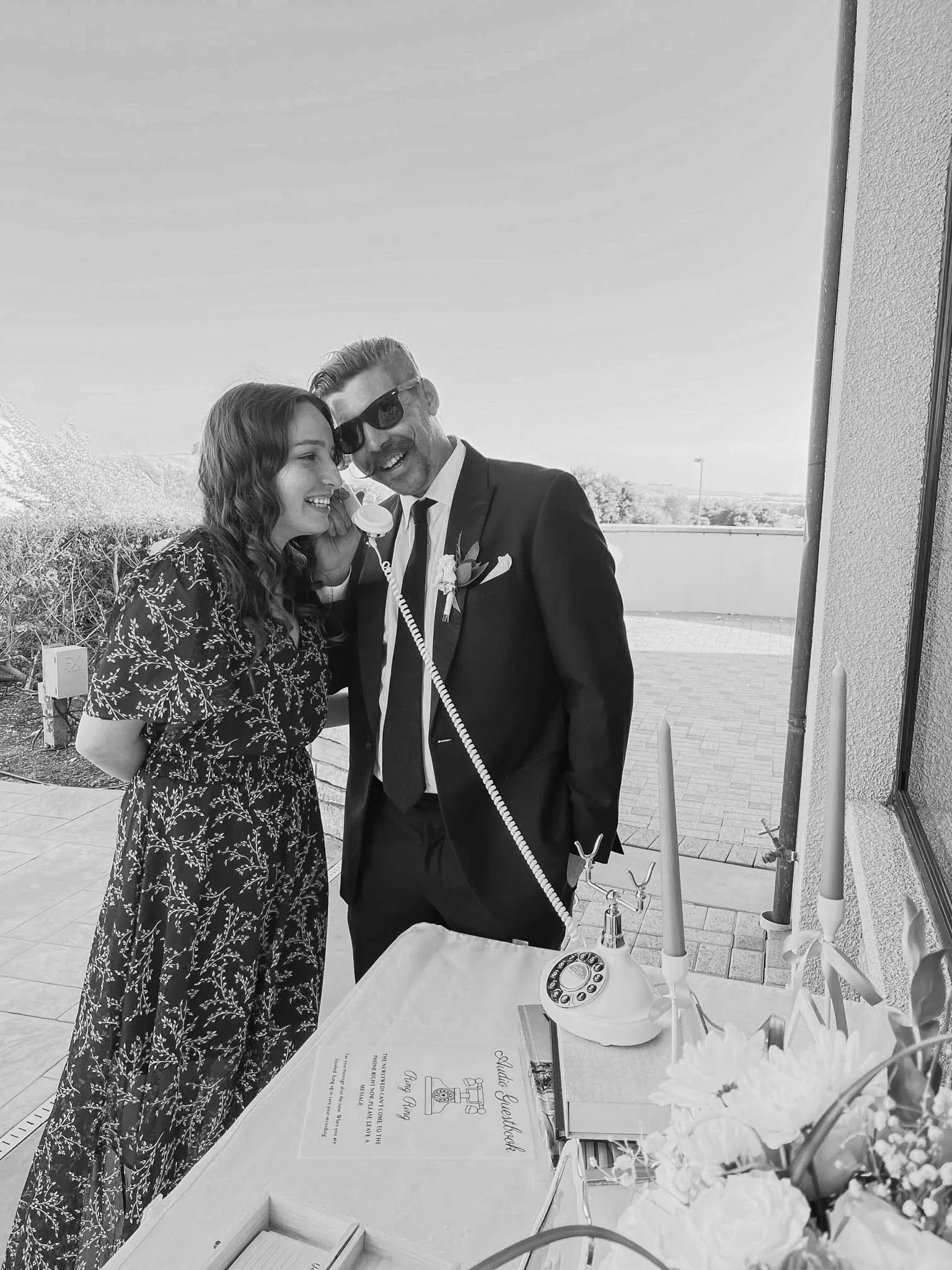 Black-and-white photograph of a couple sharing a special moment with an Audio Guest Book