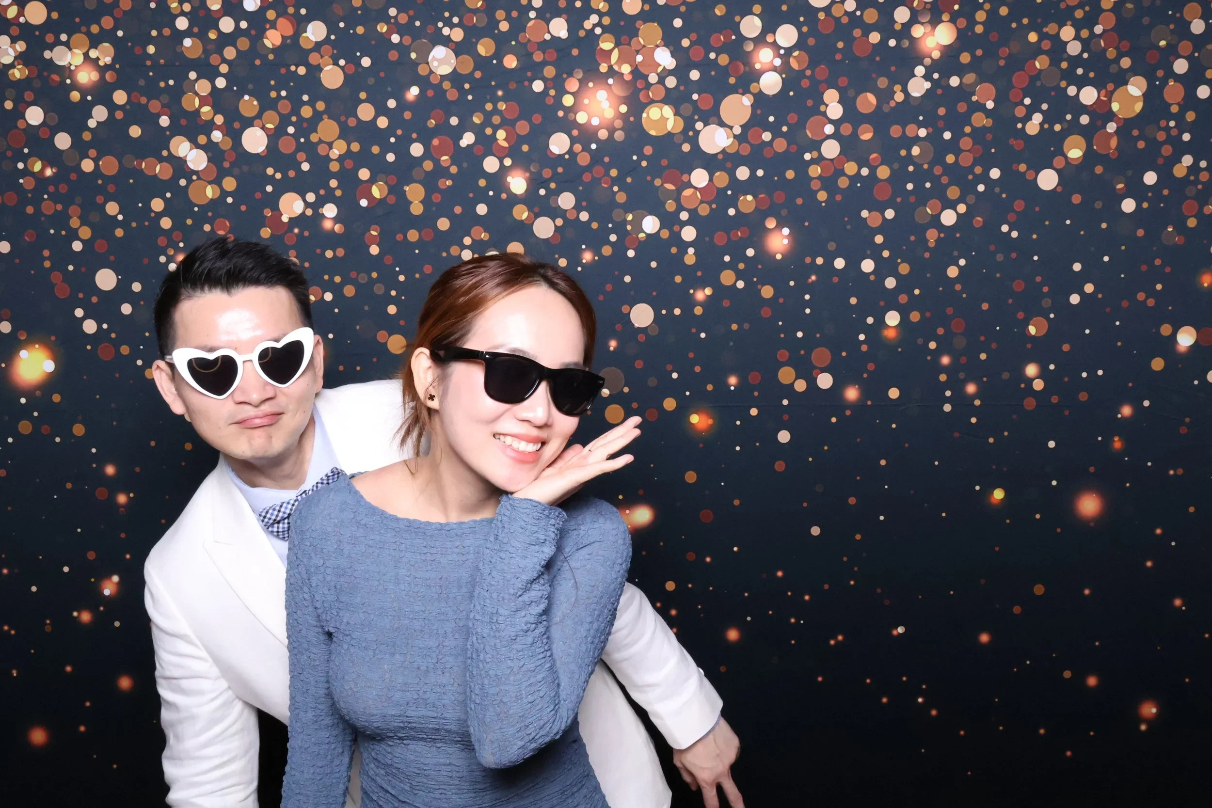 Couple posing together for a photo booth portrait at a celebration