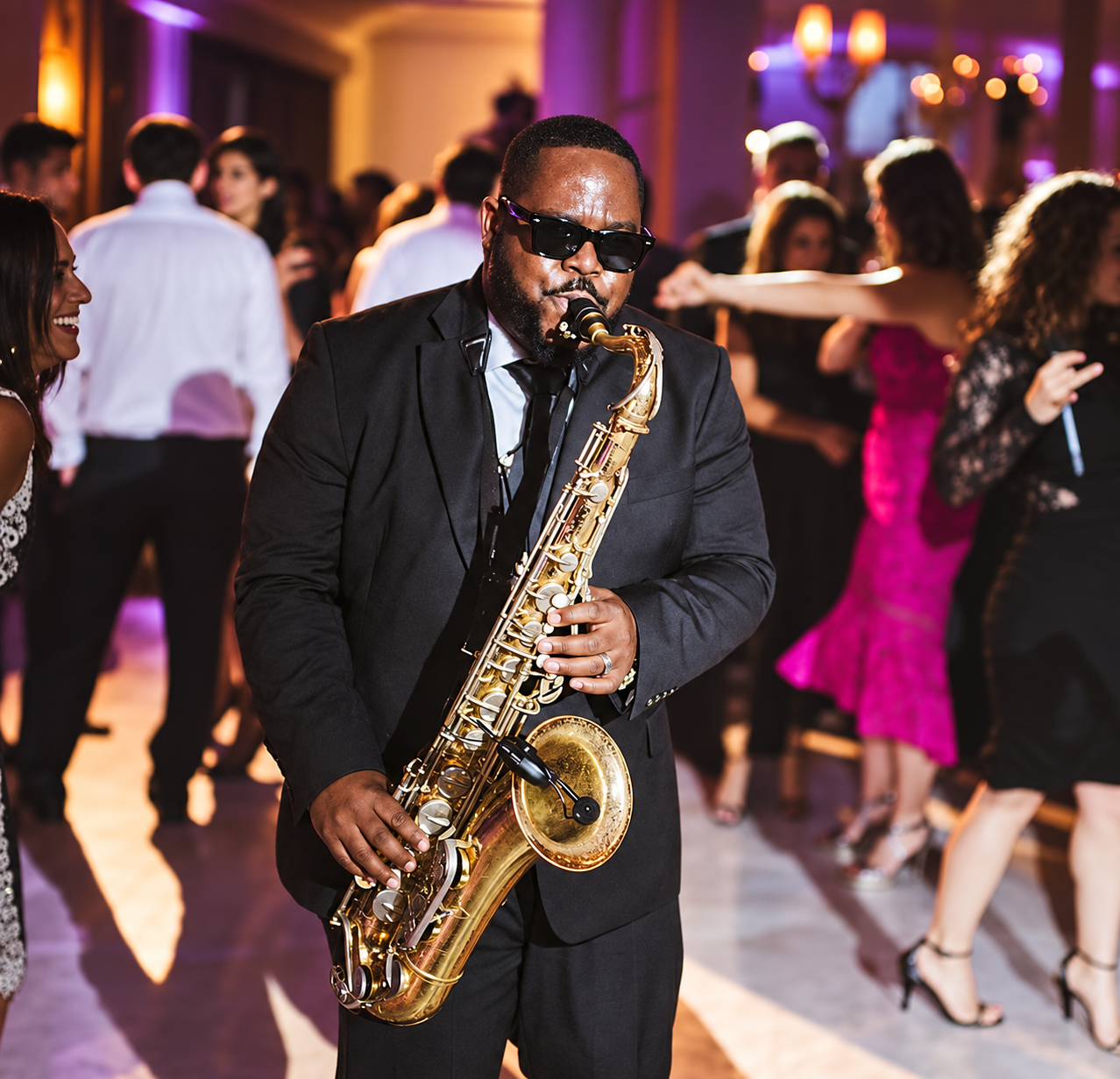 LaQuin Lay playing saxophone at a celebration
