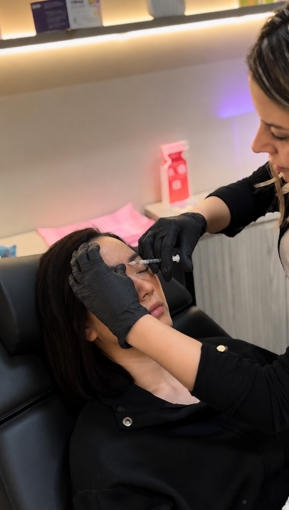 RN injector performing precision filler treatment at AURA Aesthetics Med Spa Houston TX
