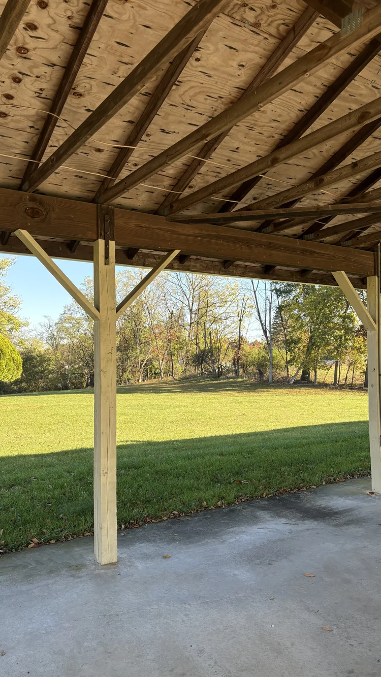 View from inside the pavilion toward the lawn and trees