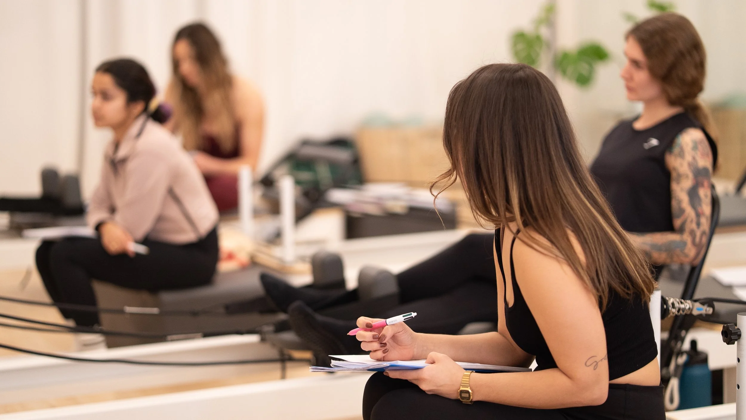 Pilates instructor guiding student on reformer