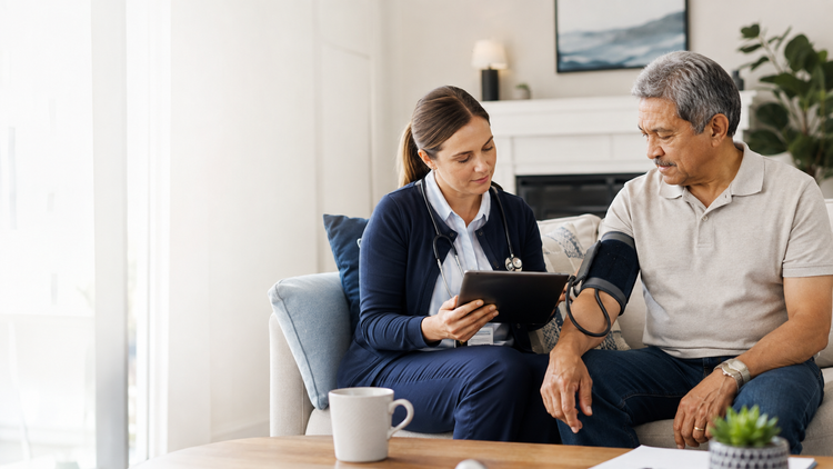 A Skilled Nurse checking an older adult patient’s blood pressure at home