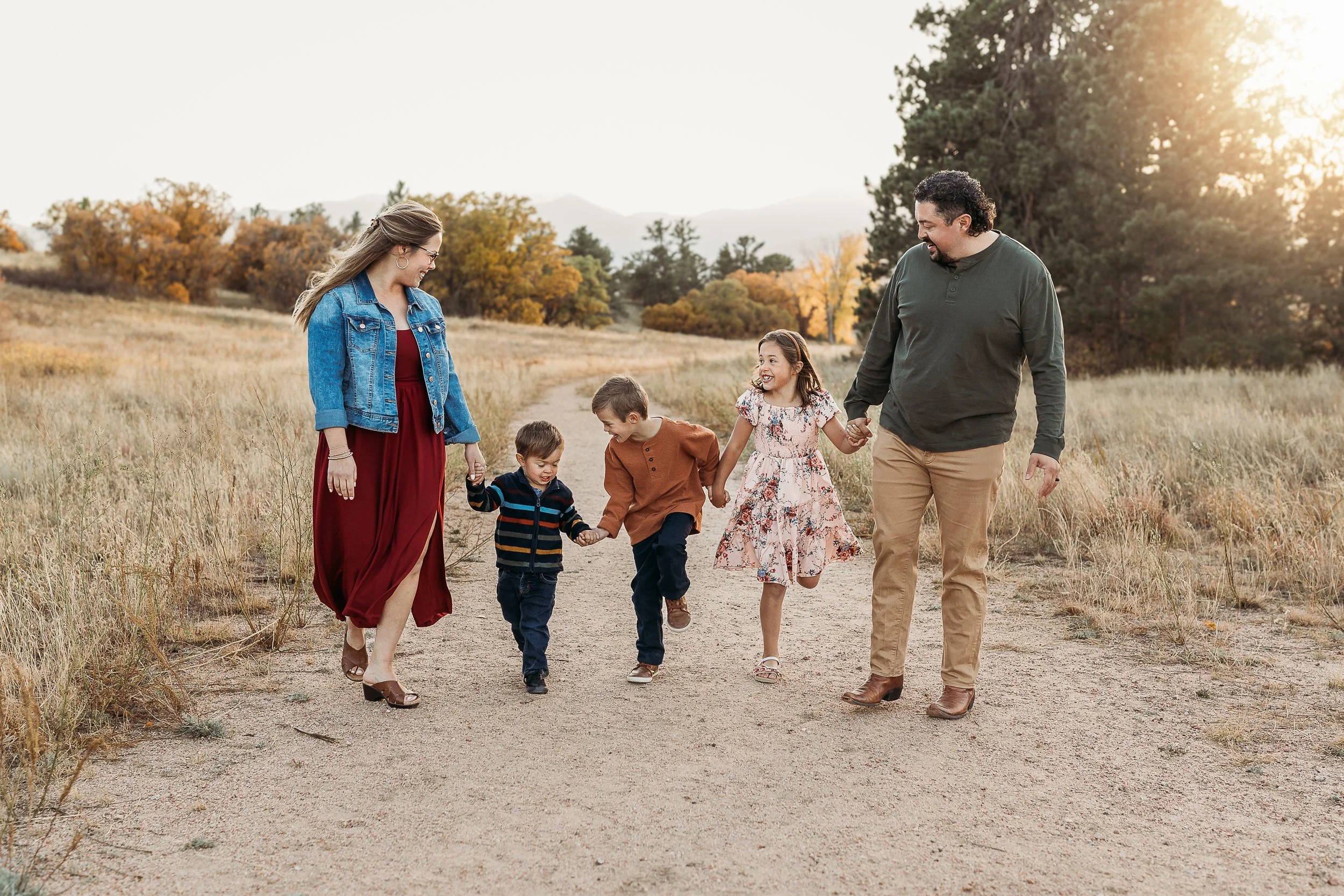 The Lohmann family — Kenneth, wife, and three children — walking together in the Colorado foothills