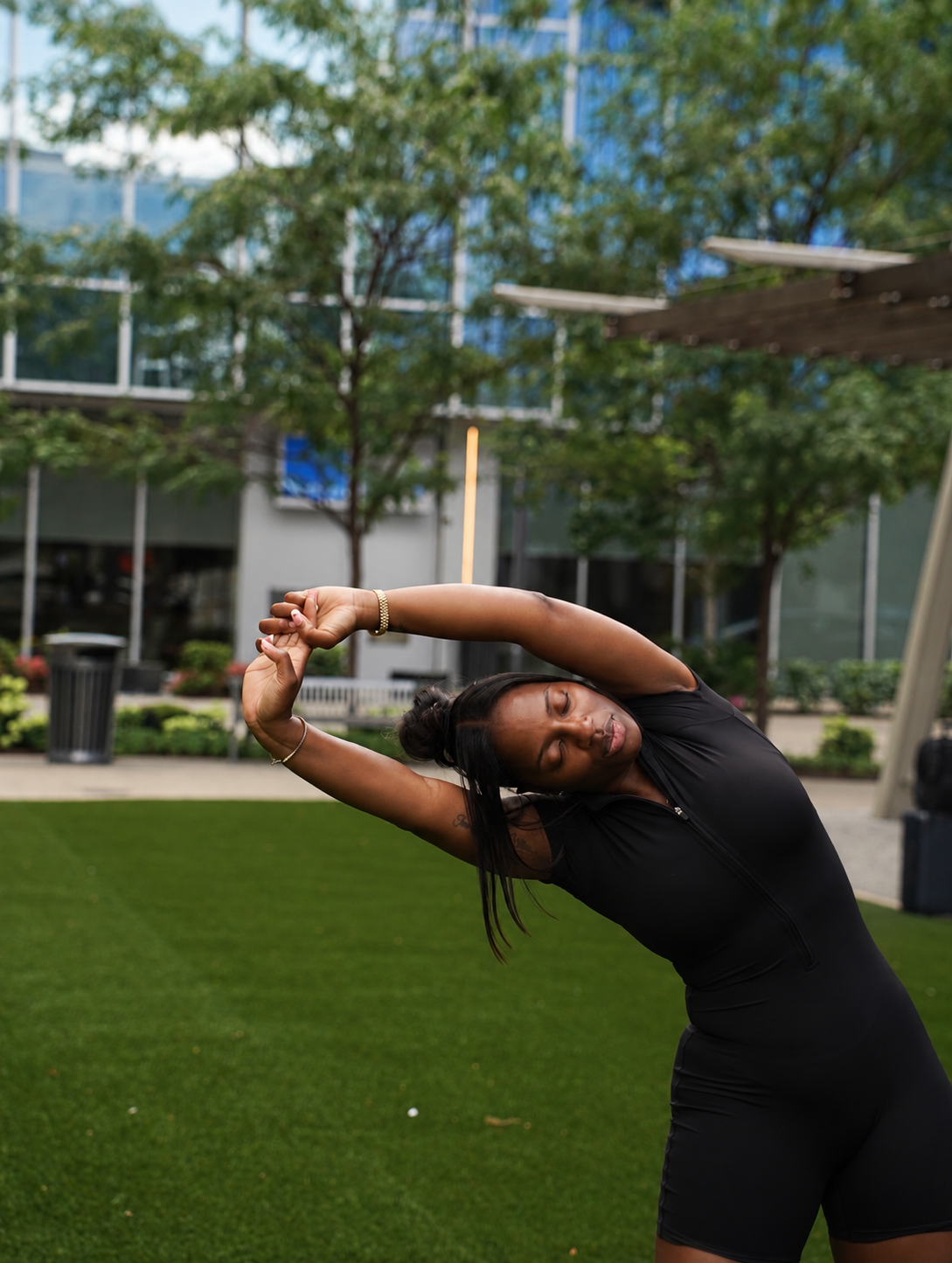 Briana stretching outdoors and taking time to care for herself