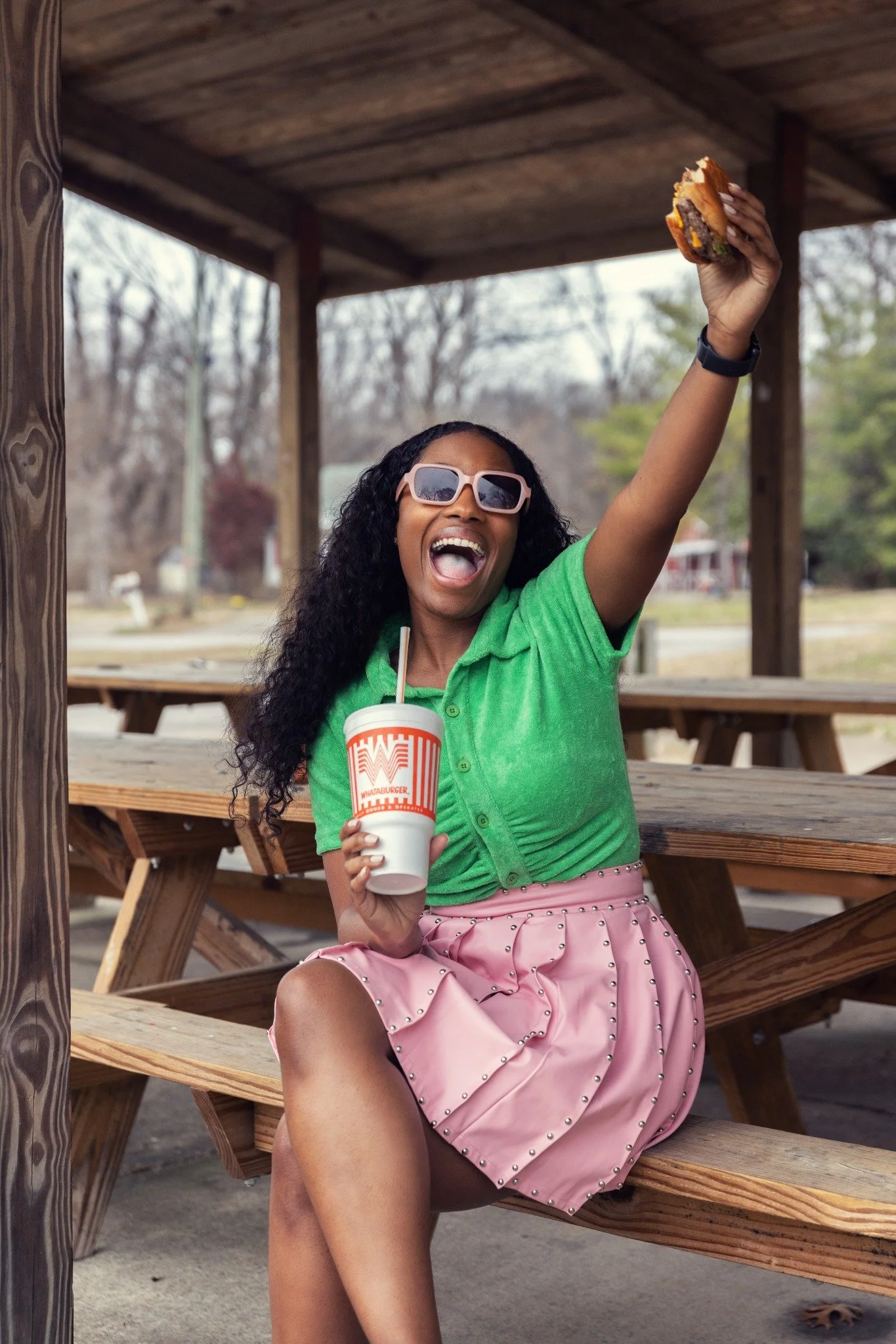 Briana smiling with Whataburger food and branded drink during a campaign