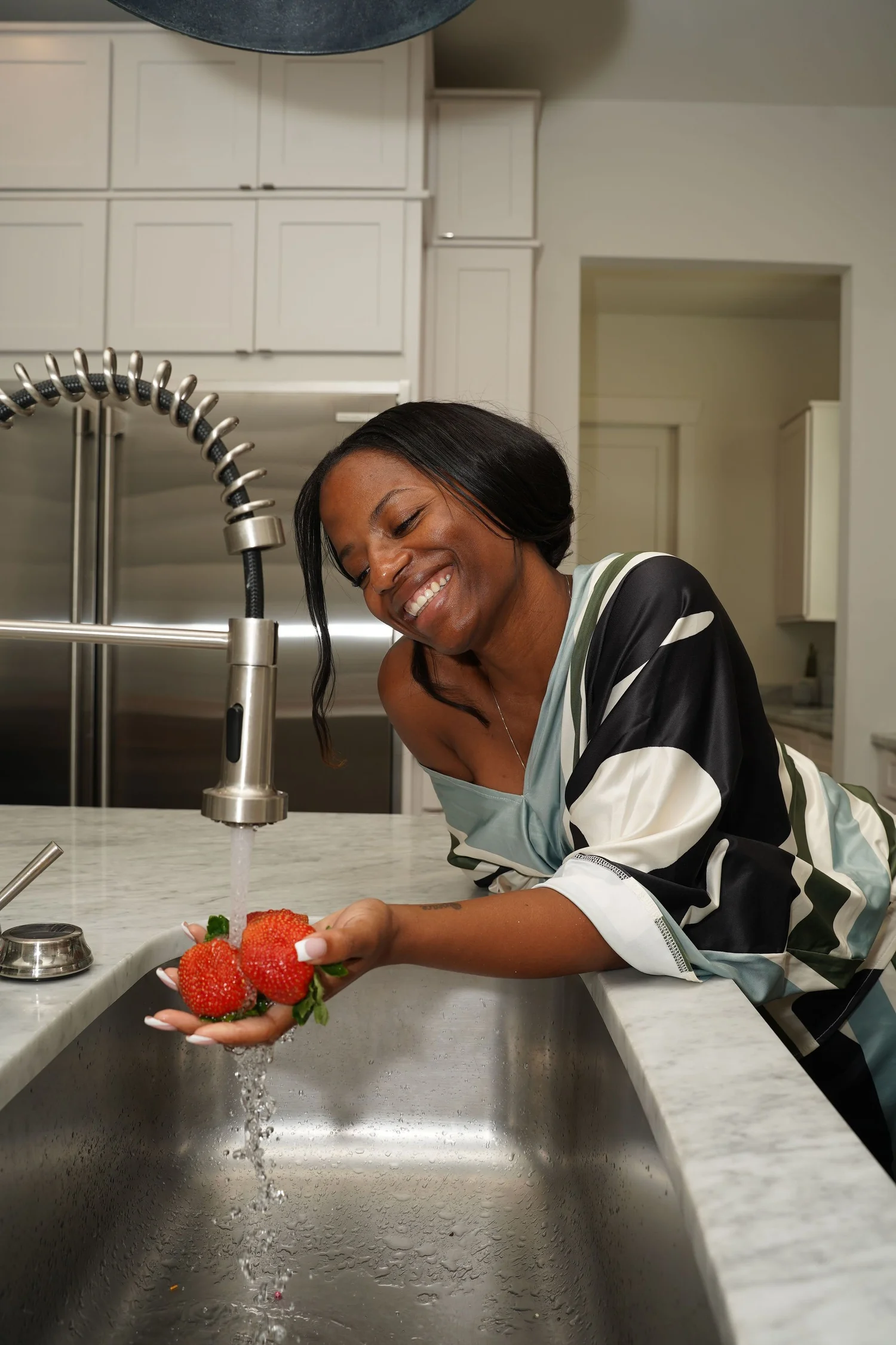 Briana preparing fresh strawberries in her kitchen