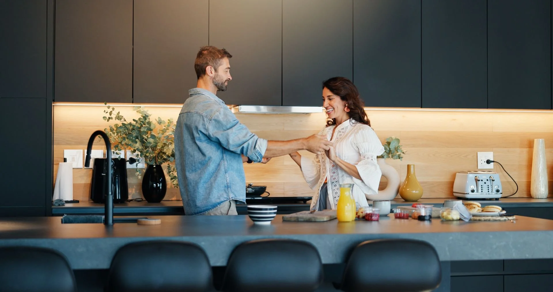 A couple dancing together in the kitchen of their home