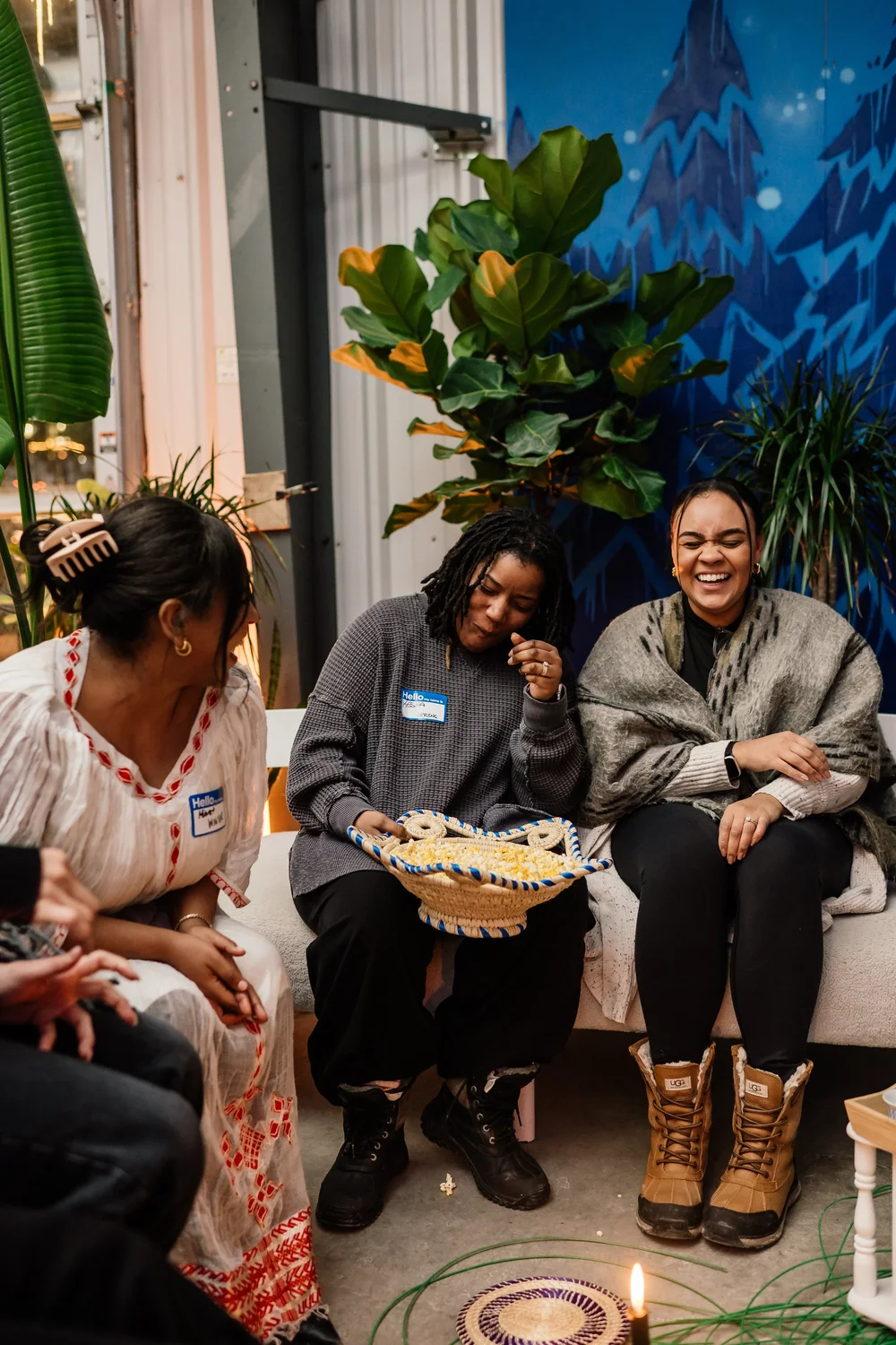 Participants laughing together on a couch