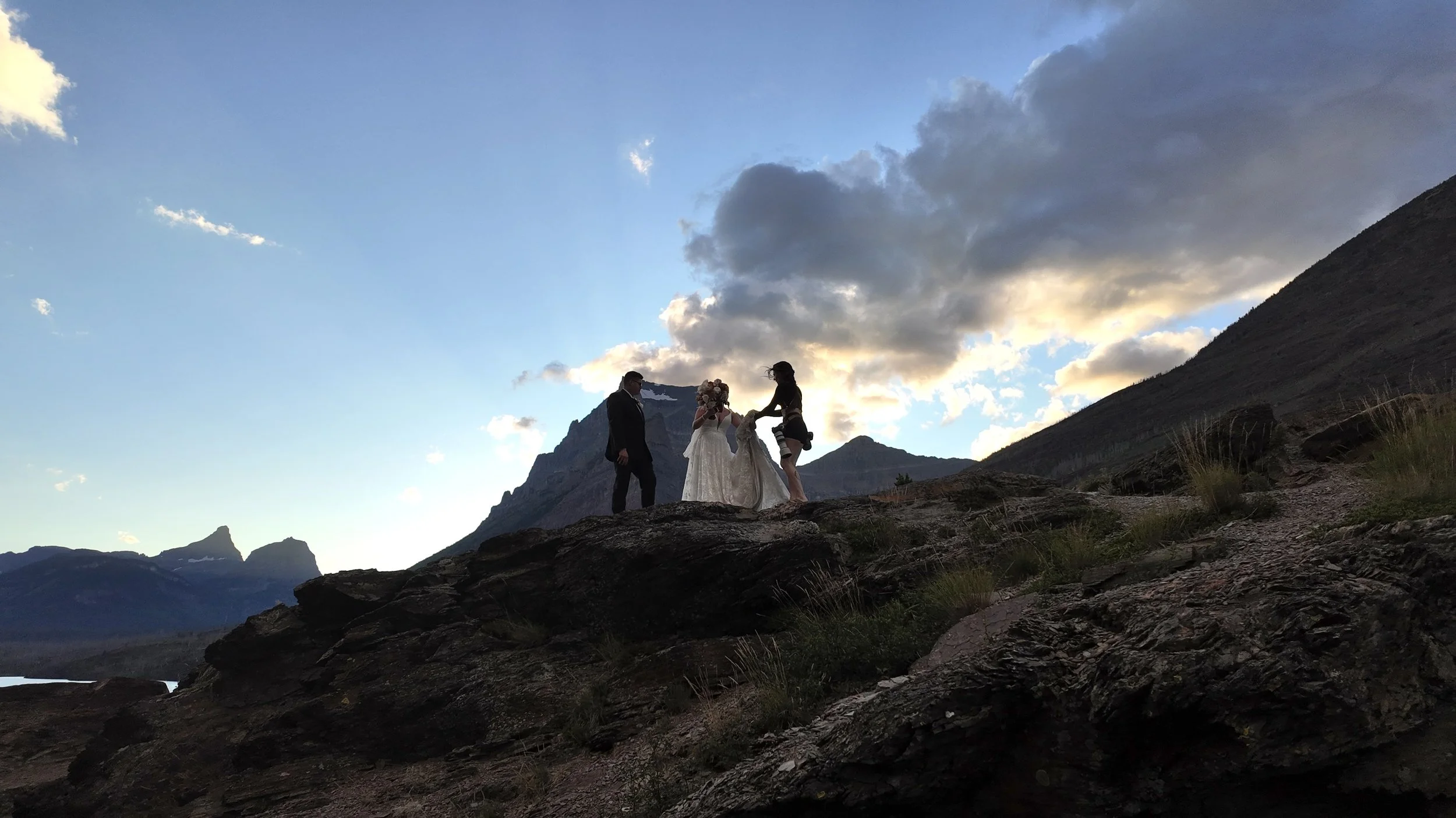 Aundrea photographing a couple by a waterfall in Montana
