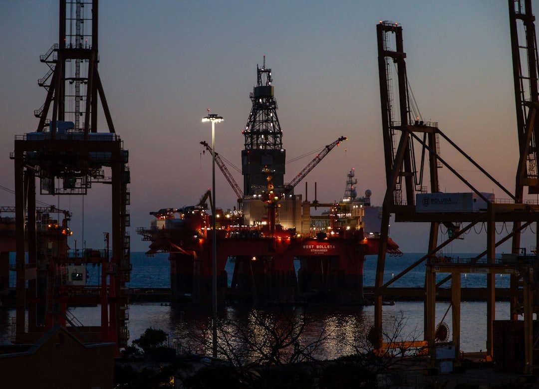 Offshore drilling rig illuminated at dusk