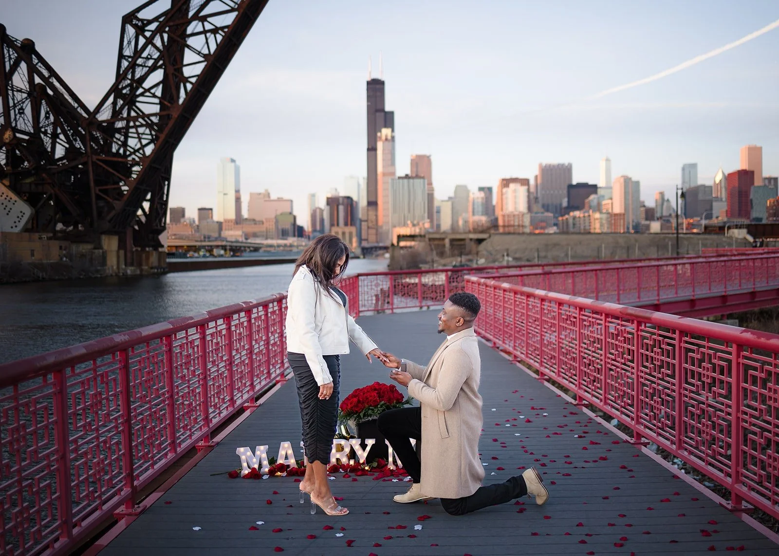Proposal photography on the red bridge at Ping Tom Memorial Park in Chinatown Chicago, with the downtown skyline behind