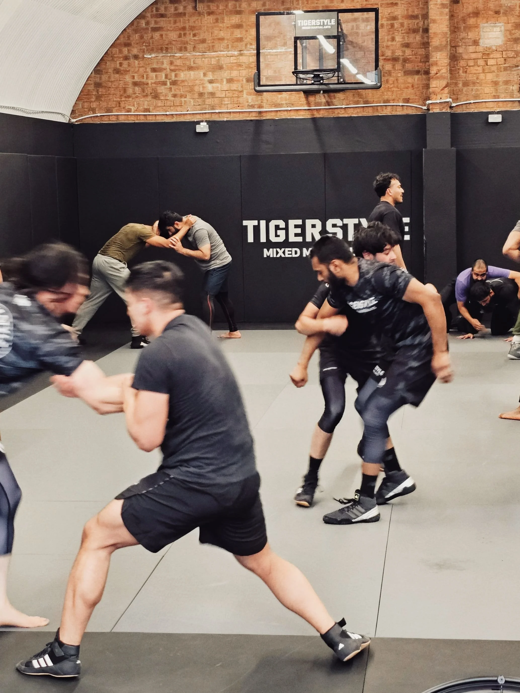 Wrestling class practising takedowns at Tigerstyle MMA in Shadwell