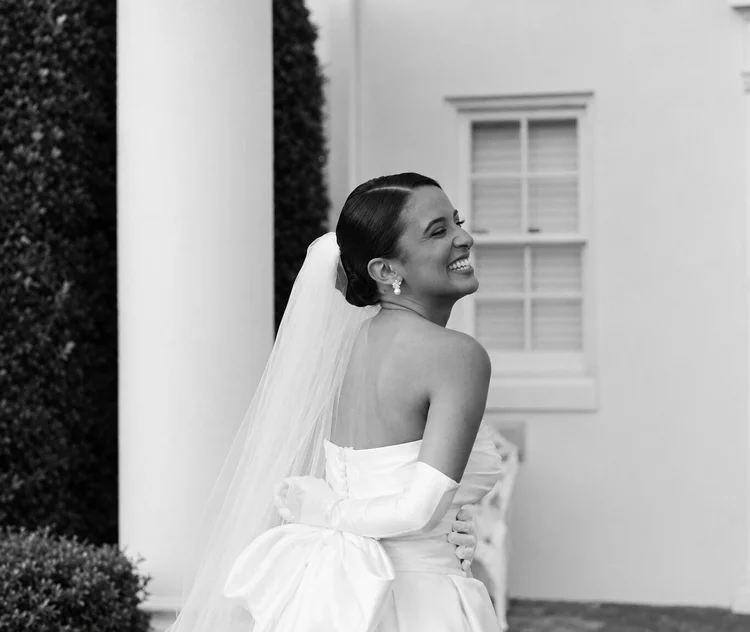 A smiling Sira bride sharing her wedding dress story.