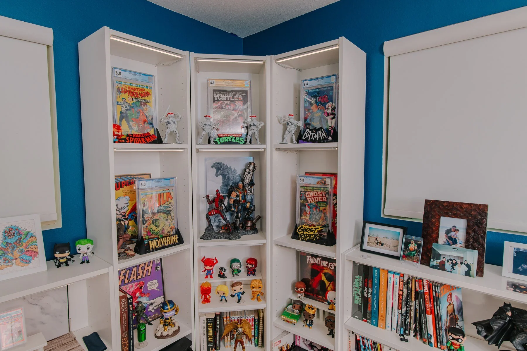 Display shelves filled with comics, figures, artwork, and collector pieces inside the studio