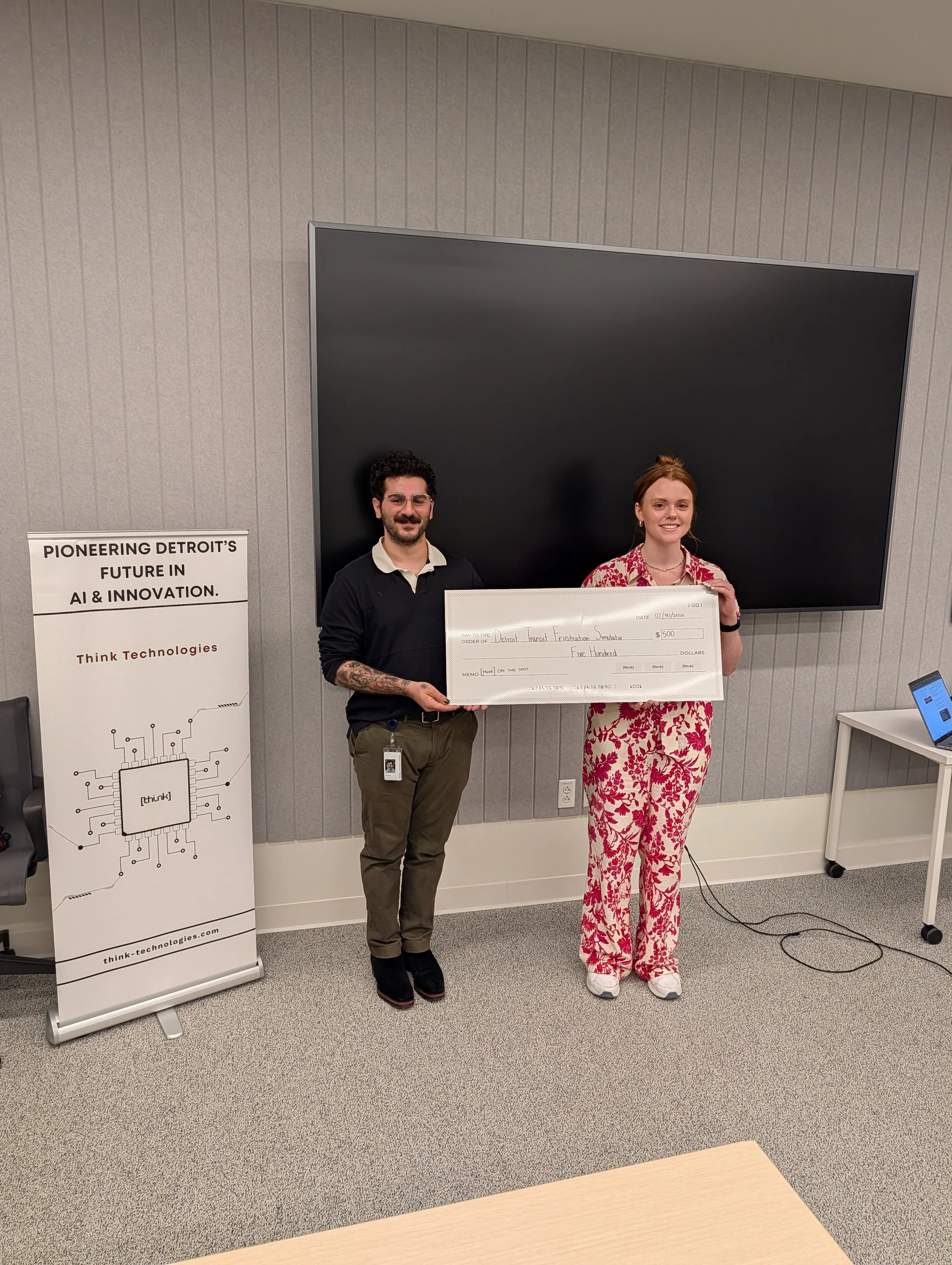 Jess Cummings and Alex Shammami holding the $500 grand prize check