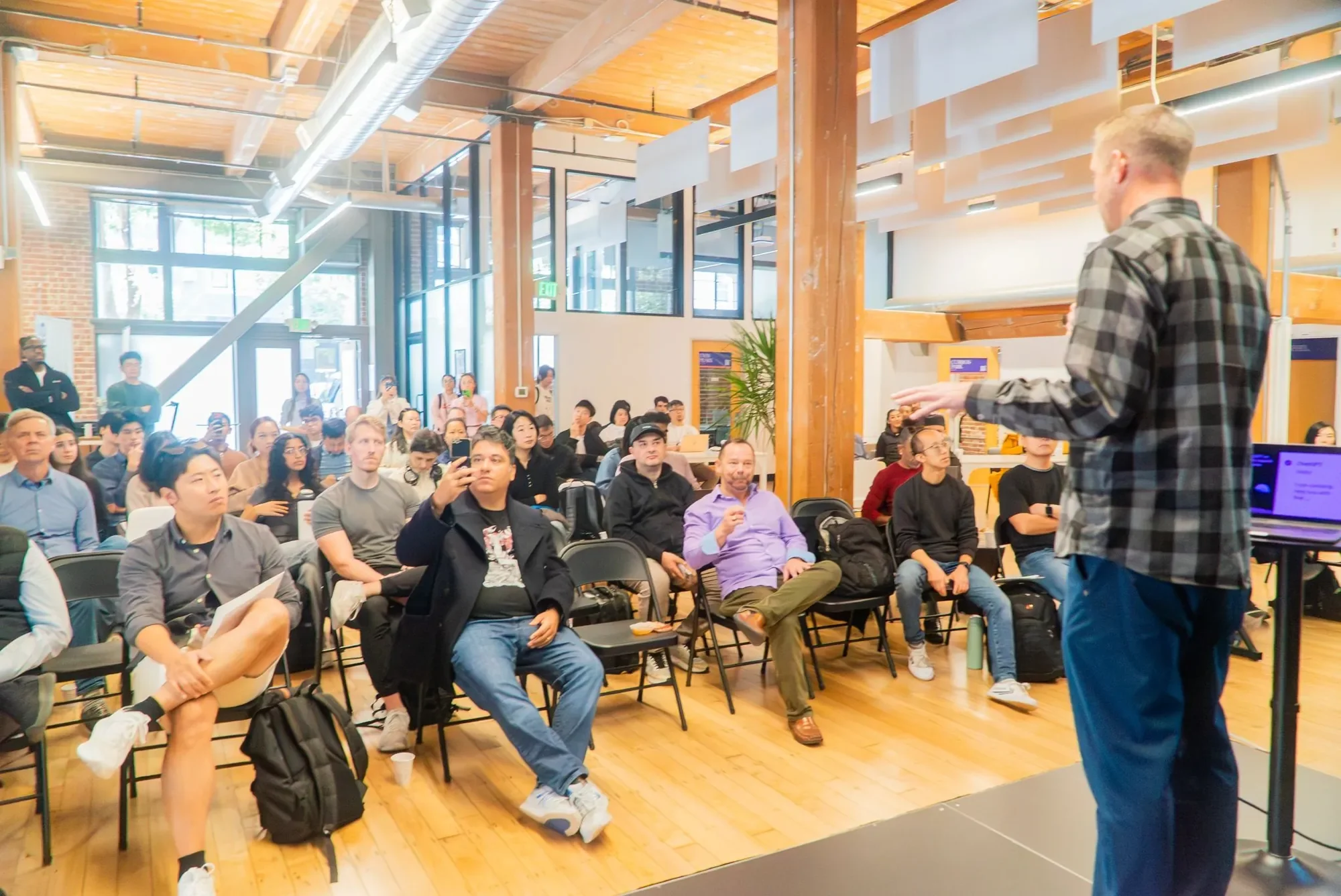 A large audience listening to a speaker at Entrepreneurs First