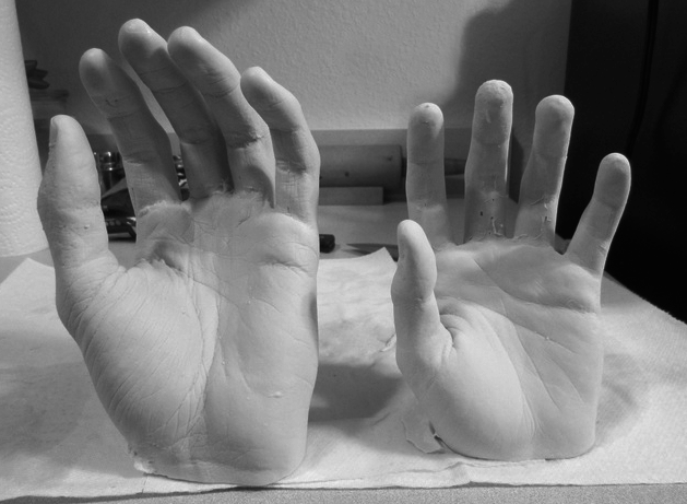 Sculptures of plaster human hands