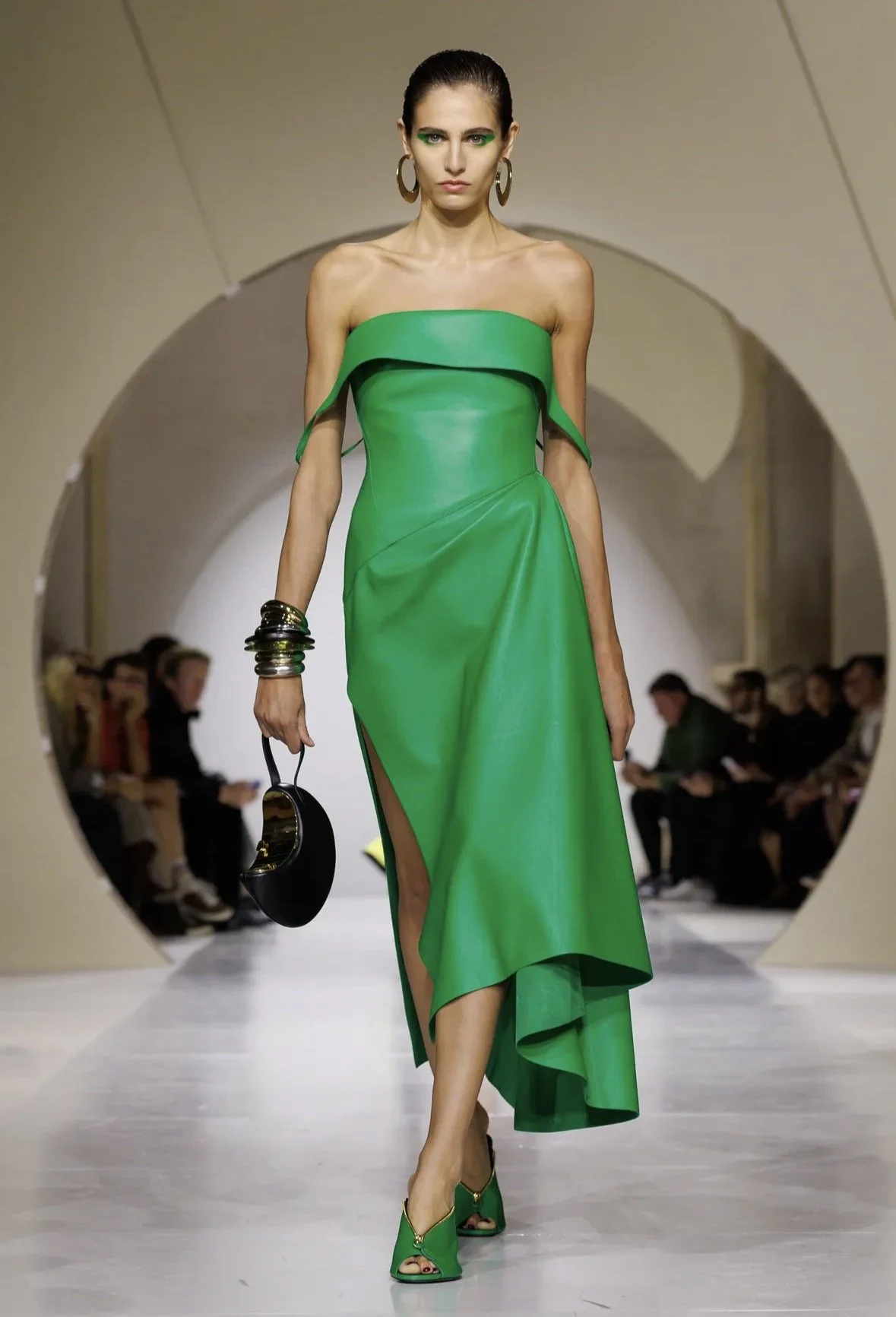 An asymmetric green dress with a folded neckline.