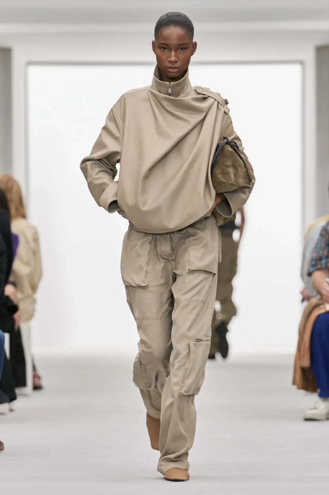Sculptural folds with relaxed cargo trousers.