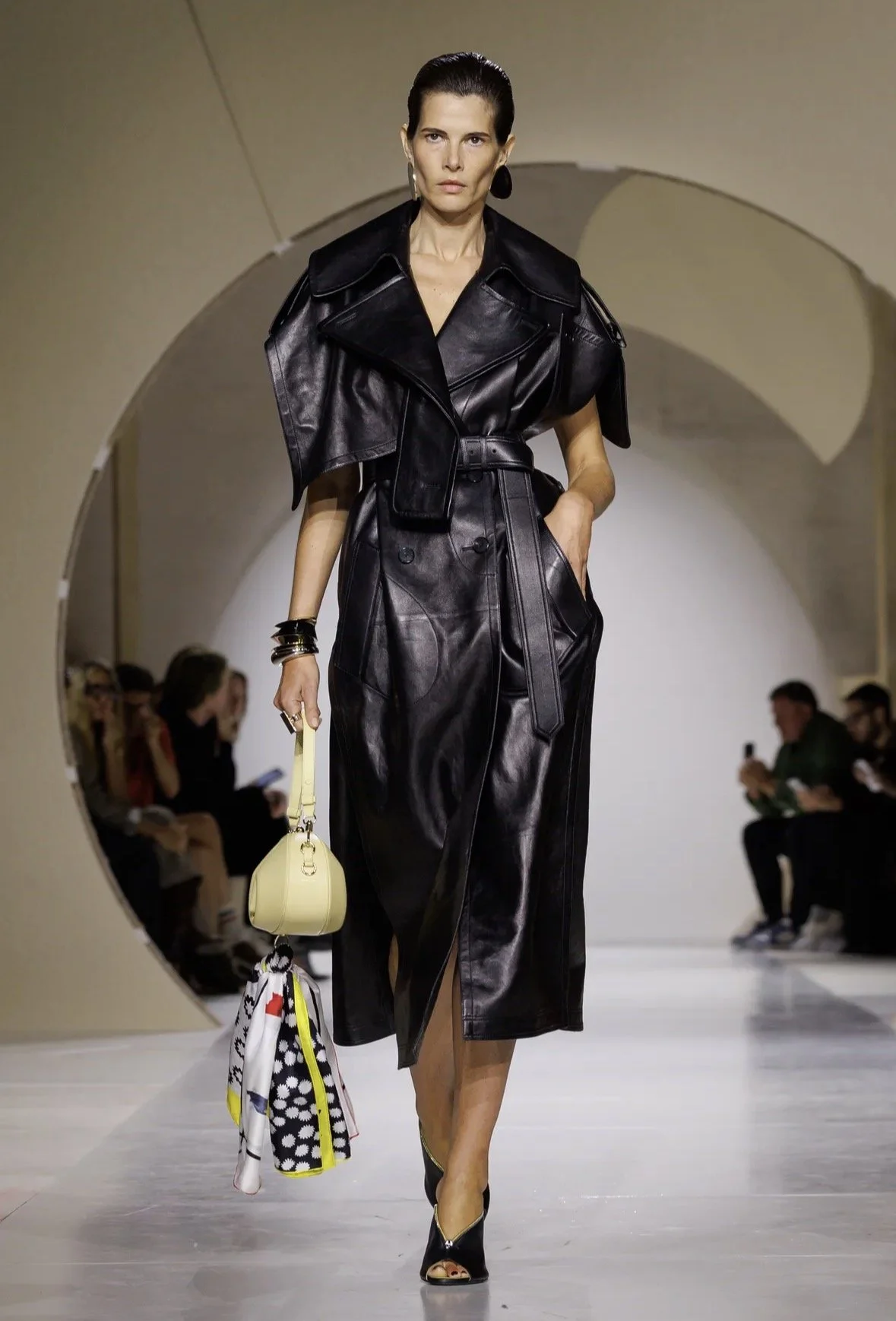 A belted trench silhouette with sculptural sleeves.