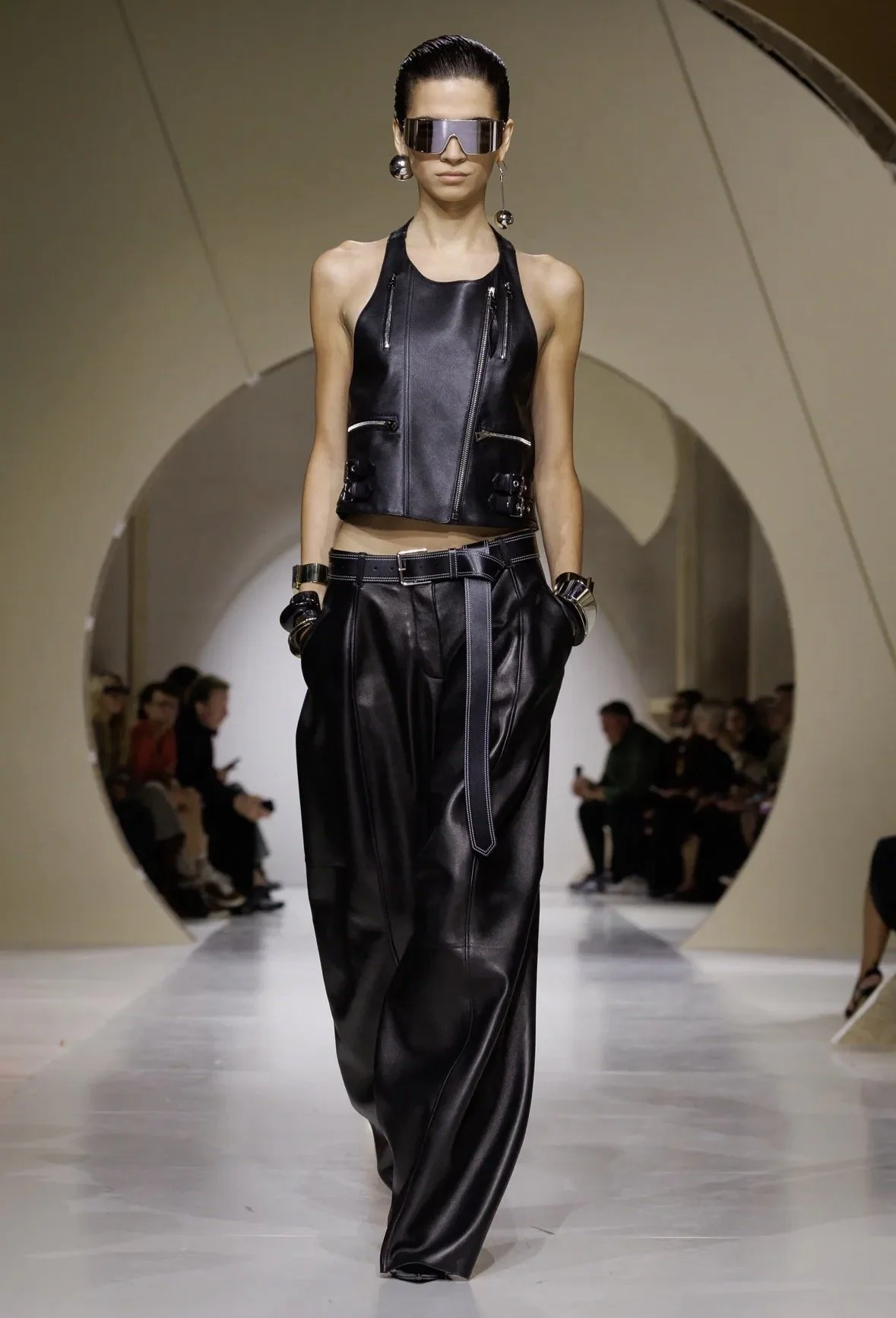 A biker-inspired vest and fluid wide-leg trousers.