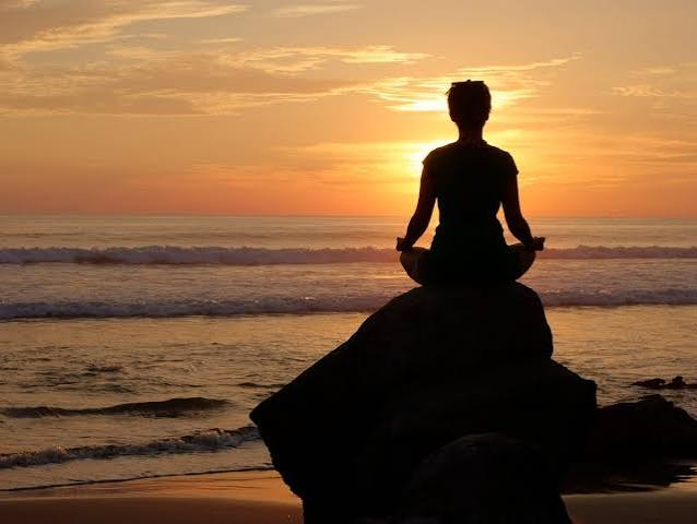 Meditating at sunset