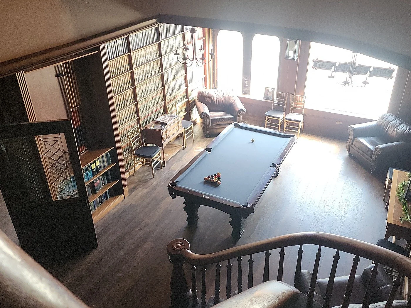 Overhead view of the billiards room and iconic spiral staircase at Your Boutique Hotel